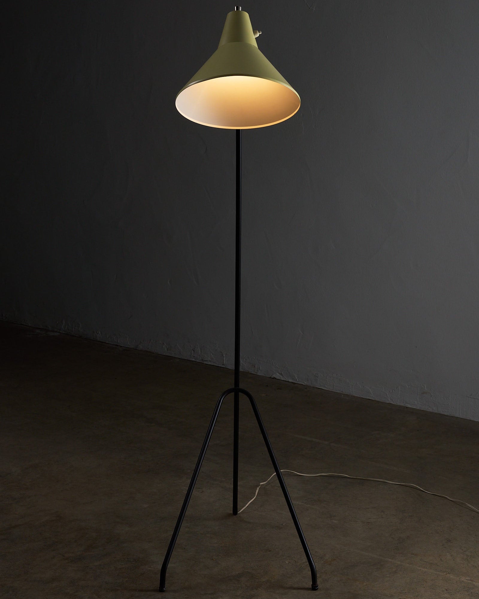 Grasshopper Tripod Floor Lamp by Willem van Doorn featuring a yellow shade and slim black tripod base.