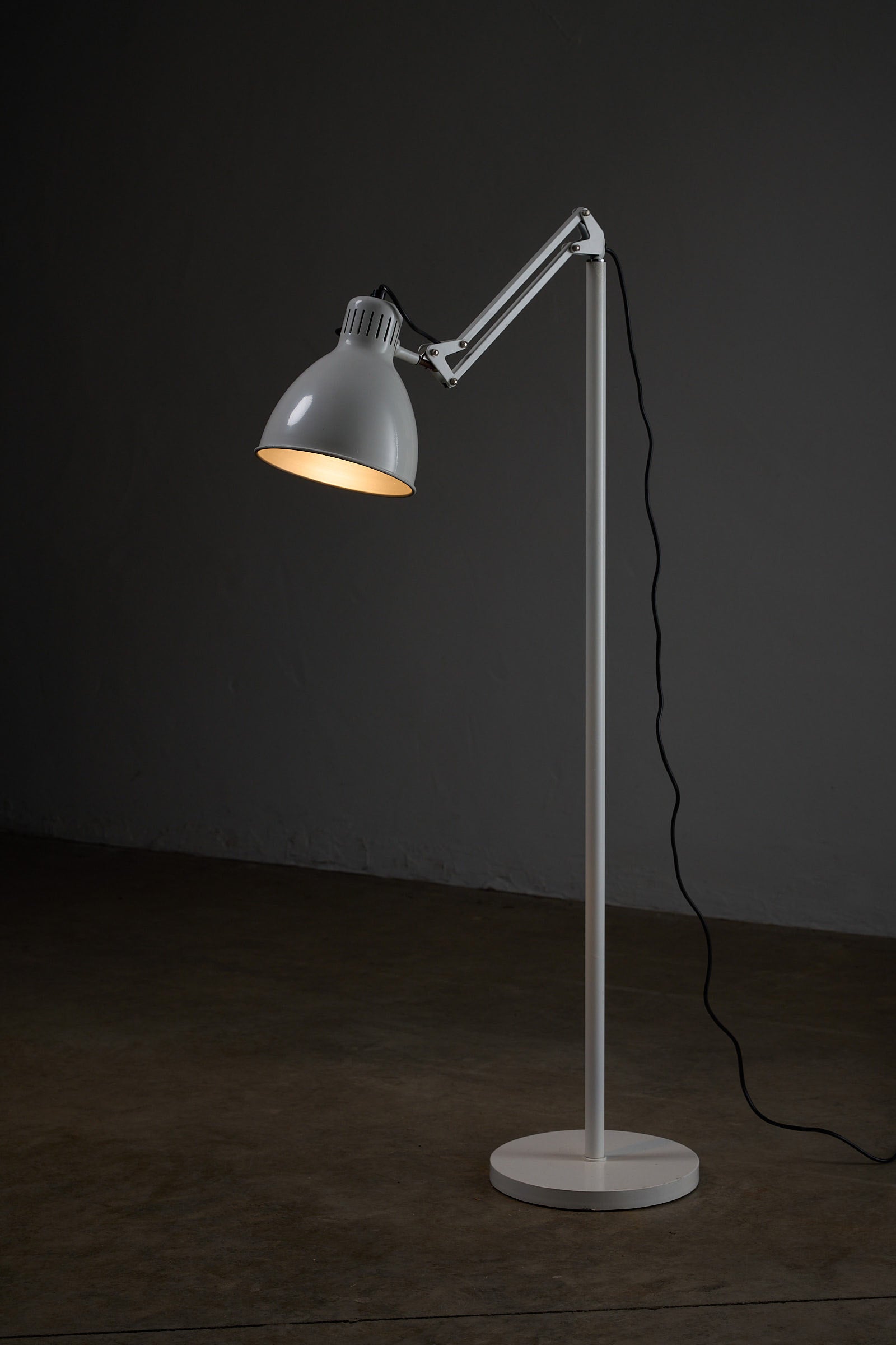 Metalarte “Arma” Adjustable Floor Lamp in White Enamel, 1970s showcasing its sleek design and illumination.