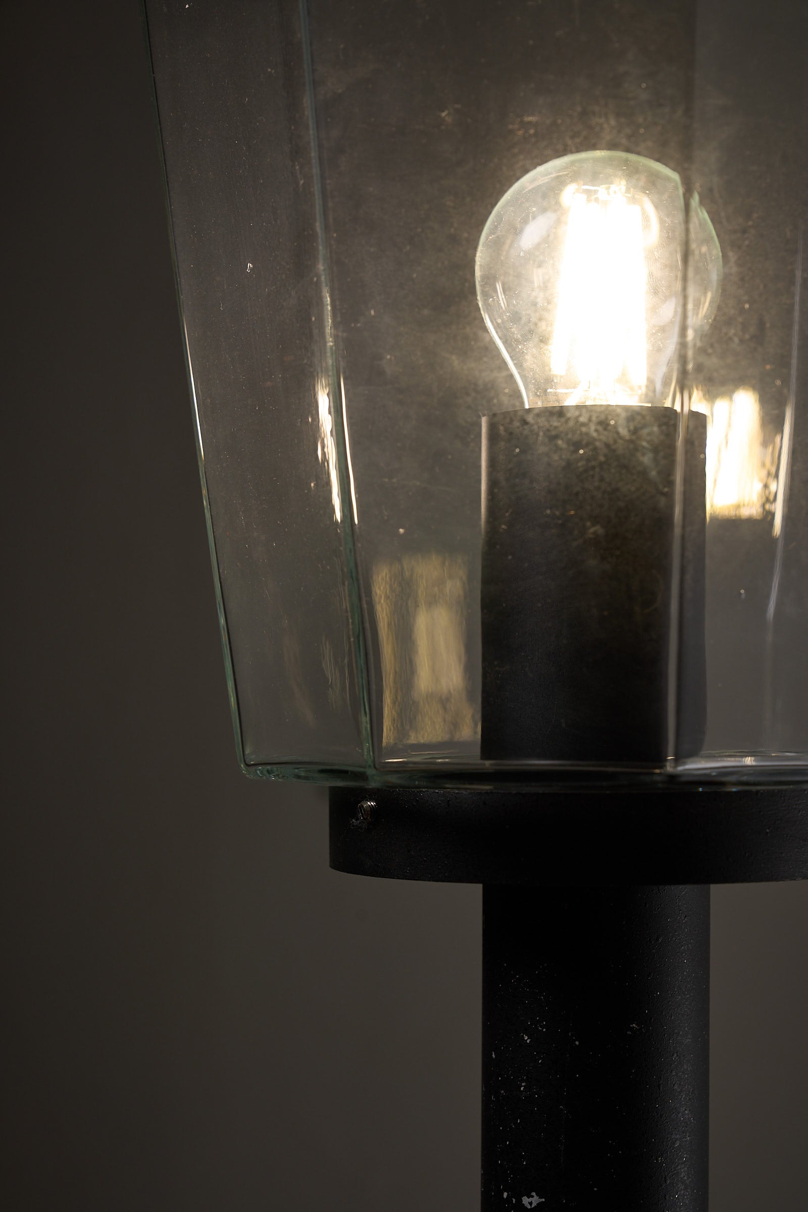 Outdoor Pole Lantern from Boom Bega featuring clear glass shade and bulb on a matte black metal pole.