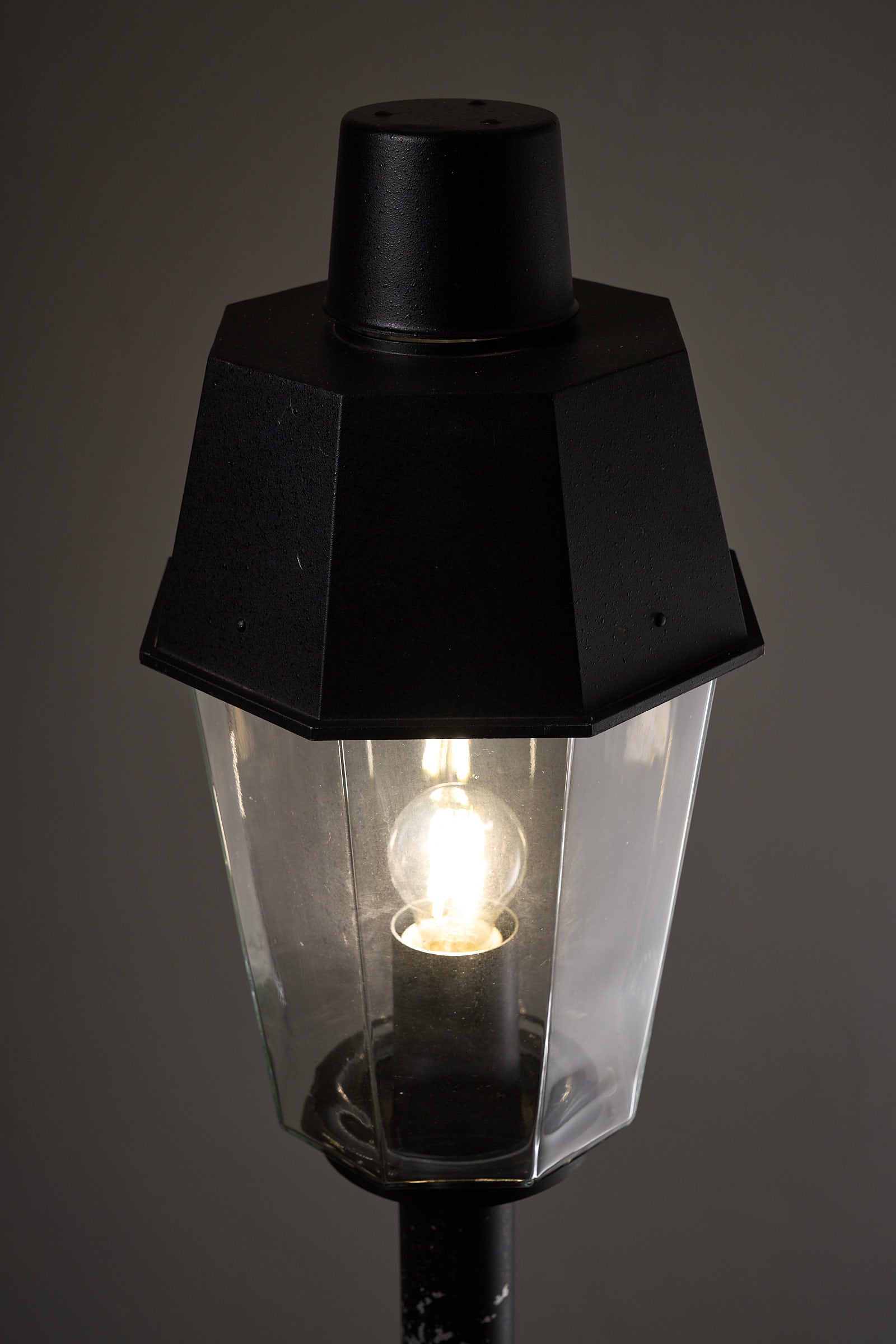 Outdoor Pole Lantern from Boom Bega with octagonal clear glass shade and matte black metal base.