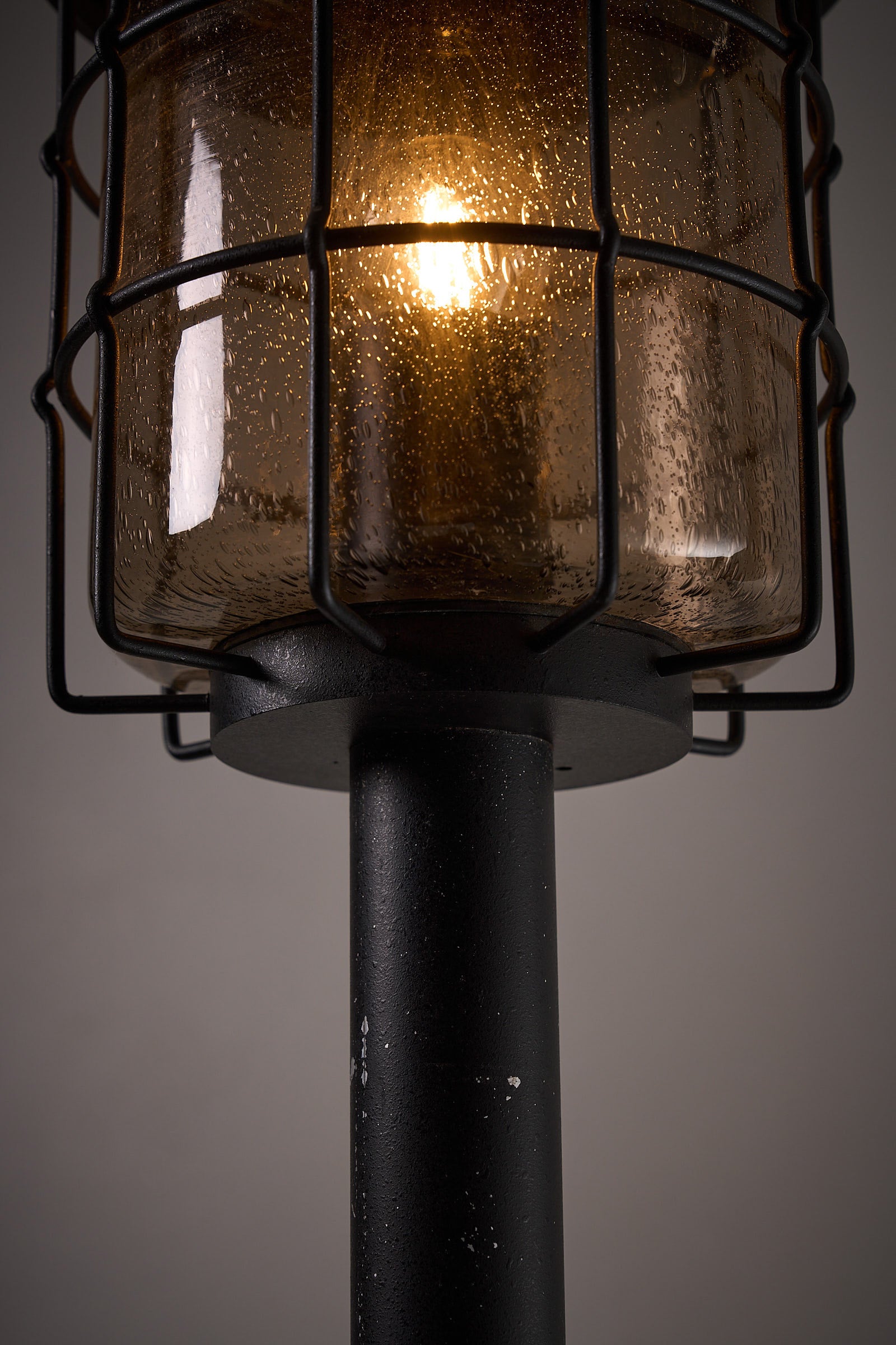 Tall Outdoor Lantern by Boom BEGA with a protective glass enclosure and metal cage, showcasing vintage design.