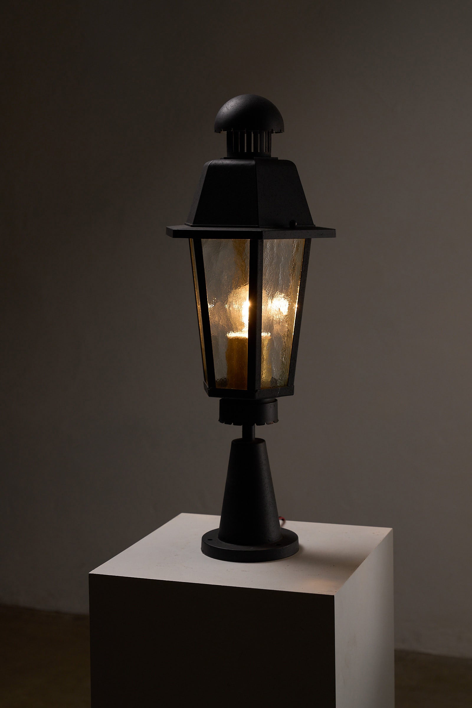 Boom BEGA Outdoor Lantern Medium with a textured glass diffuser illuminating a dark space.
