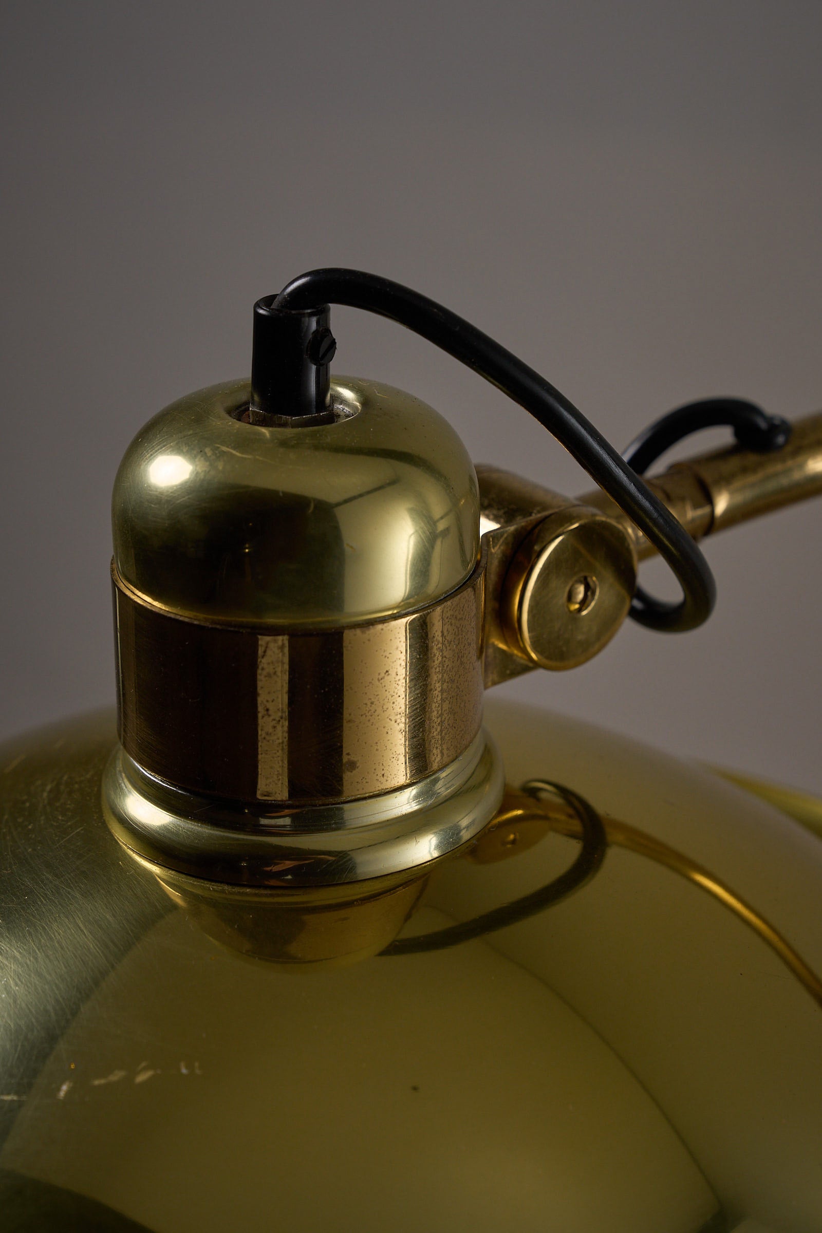 Close-up of the Cosack Brass Table Lamp with Curved Arm showcasing its polished brass details and elegant design.
