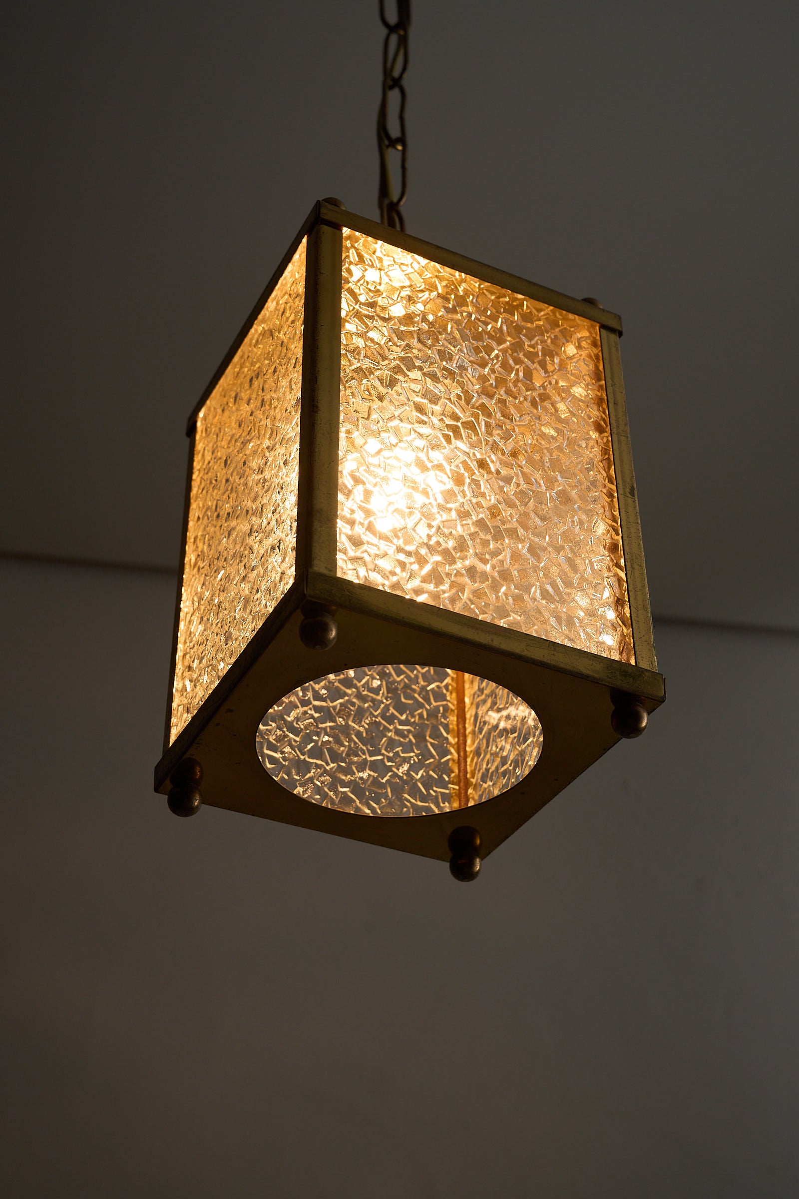 Mid-Century Brass Pendant Lamp with Textured Glass Shade featuring a cubic design and warm ambient light.