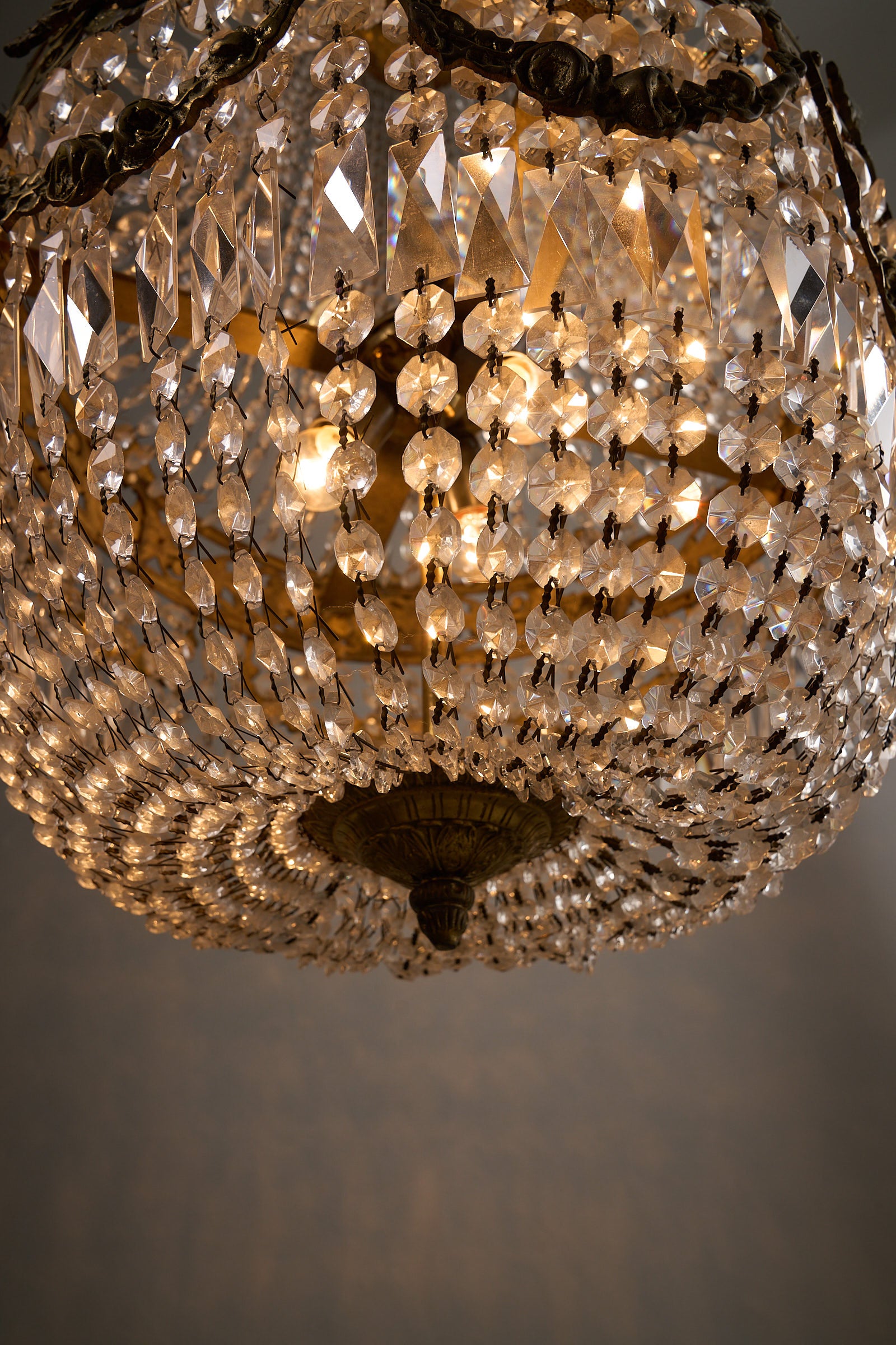Medium Empire-Style Brass and Crystal Chandelier with Garland Detailing, 20th Century featuring crystal beads and warm light.