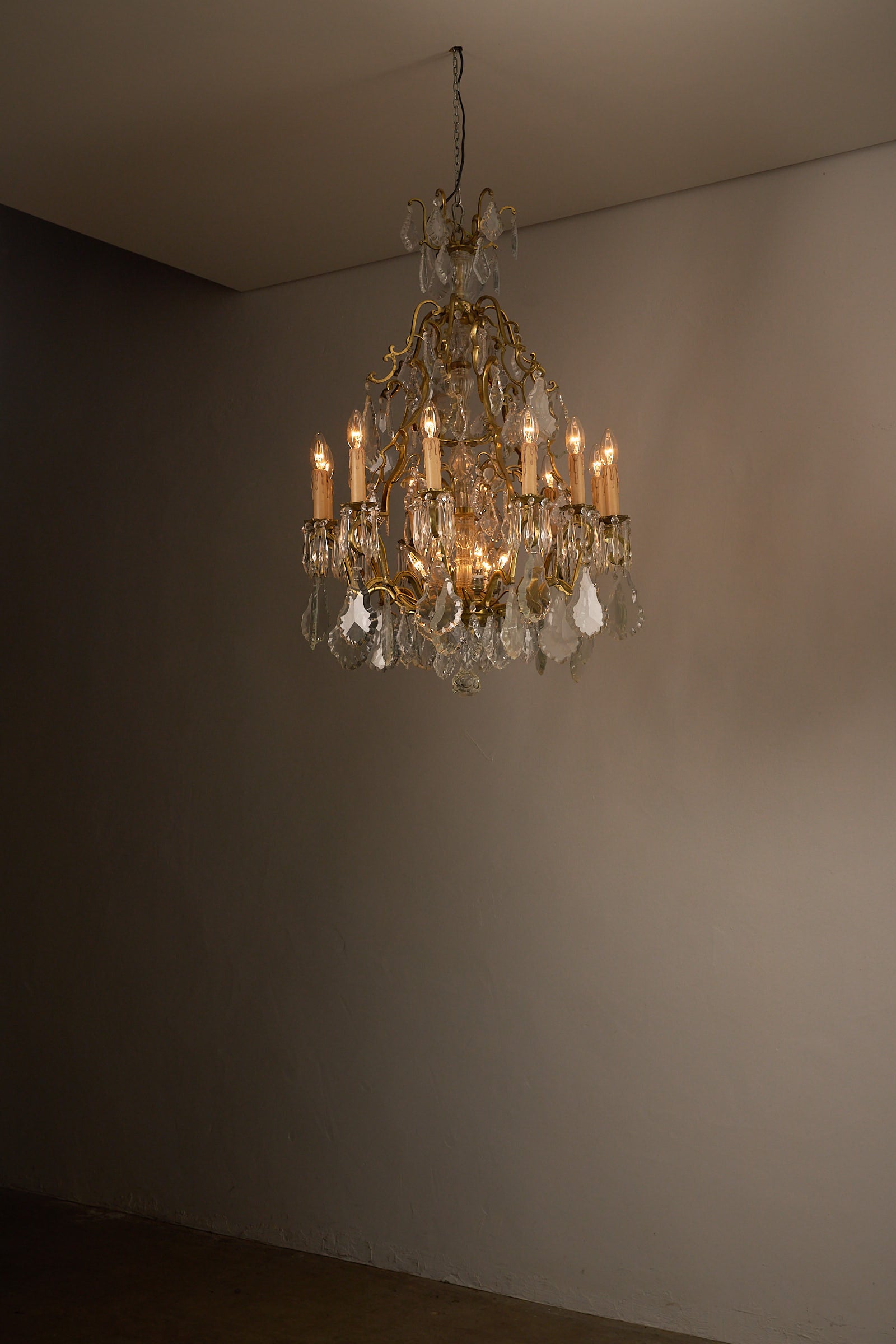 Empire-Style Chandelier in Brass and Crystal elegantly illuminating a room with its ornate design and crystal accents.