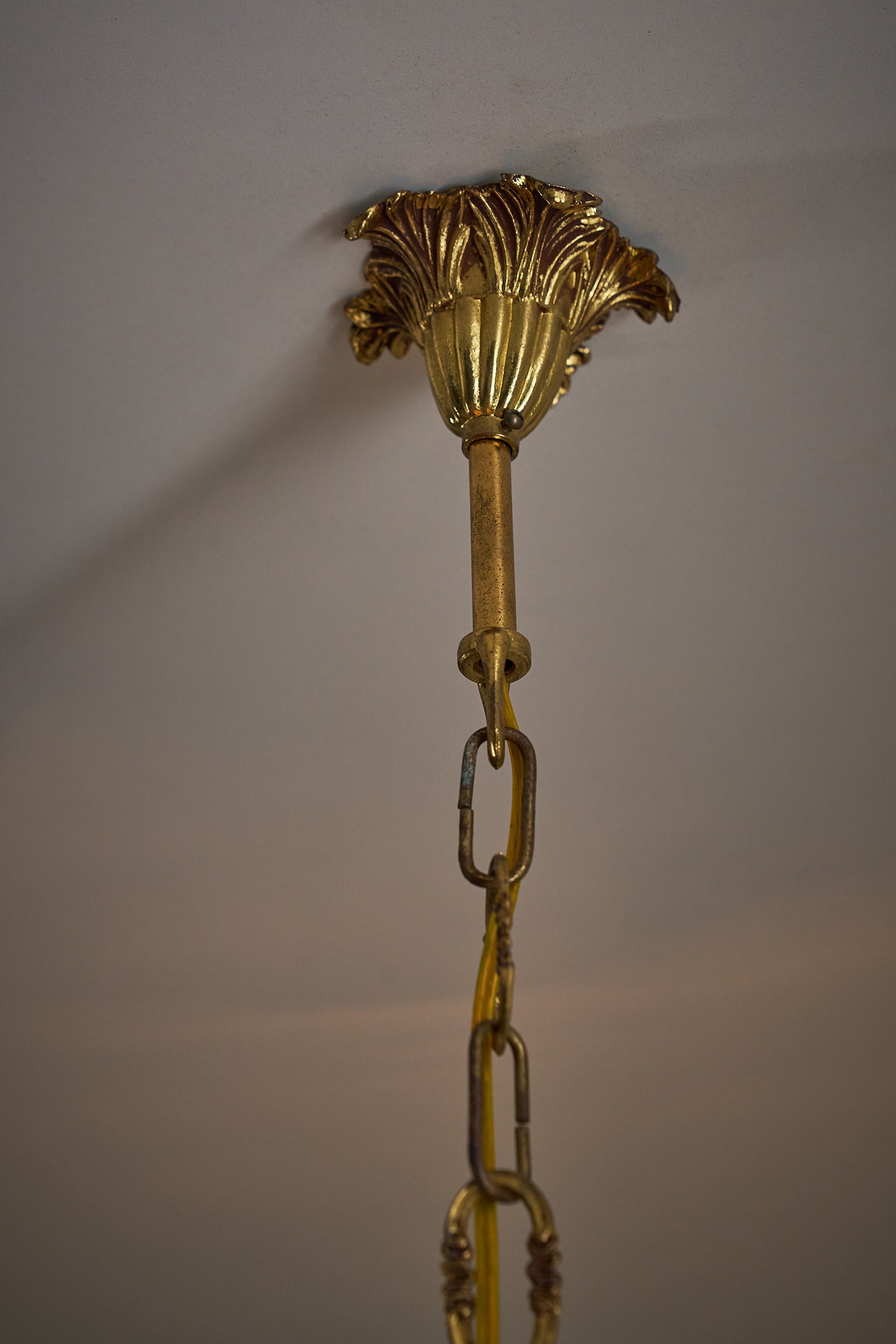 Rococo-Style Gilt Pendant Lamp with Structured Amber Glass ceiling rose and decorative chain detail.