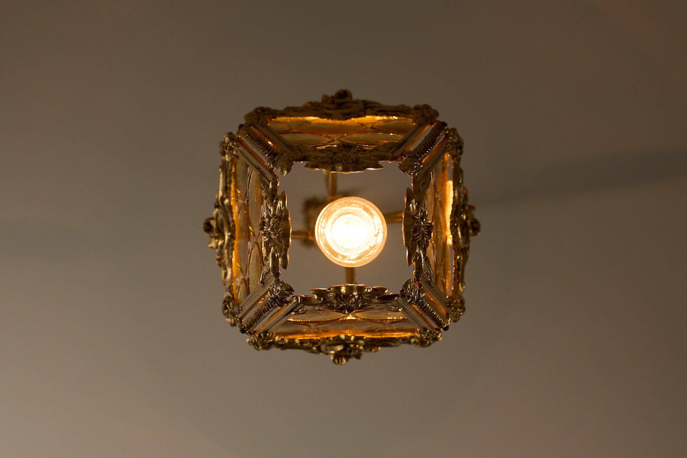 Rococo-Style Gilt Pendant Lamp with Structured Amber Glass viewed from above, showcasing ornate design and warm light.
