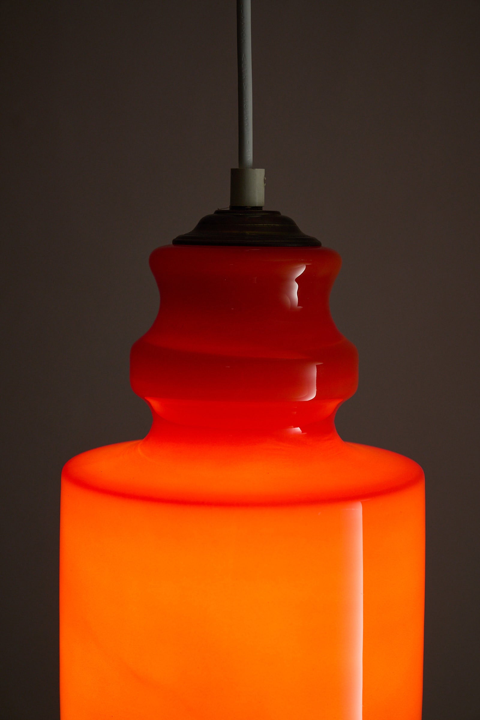 Orange Glass Pendant Lamp with glossy orange glass shade and softly rounded form.