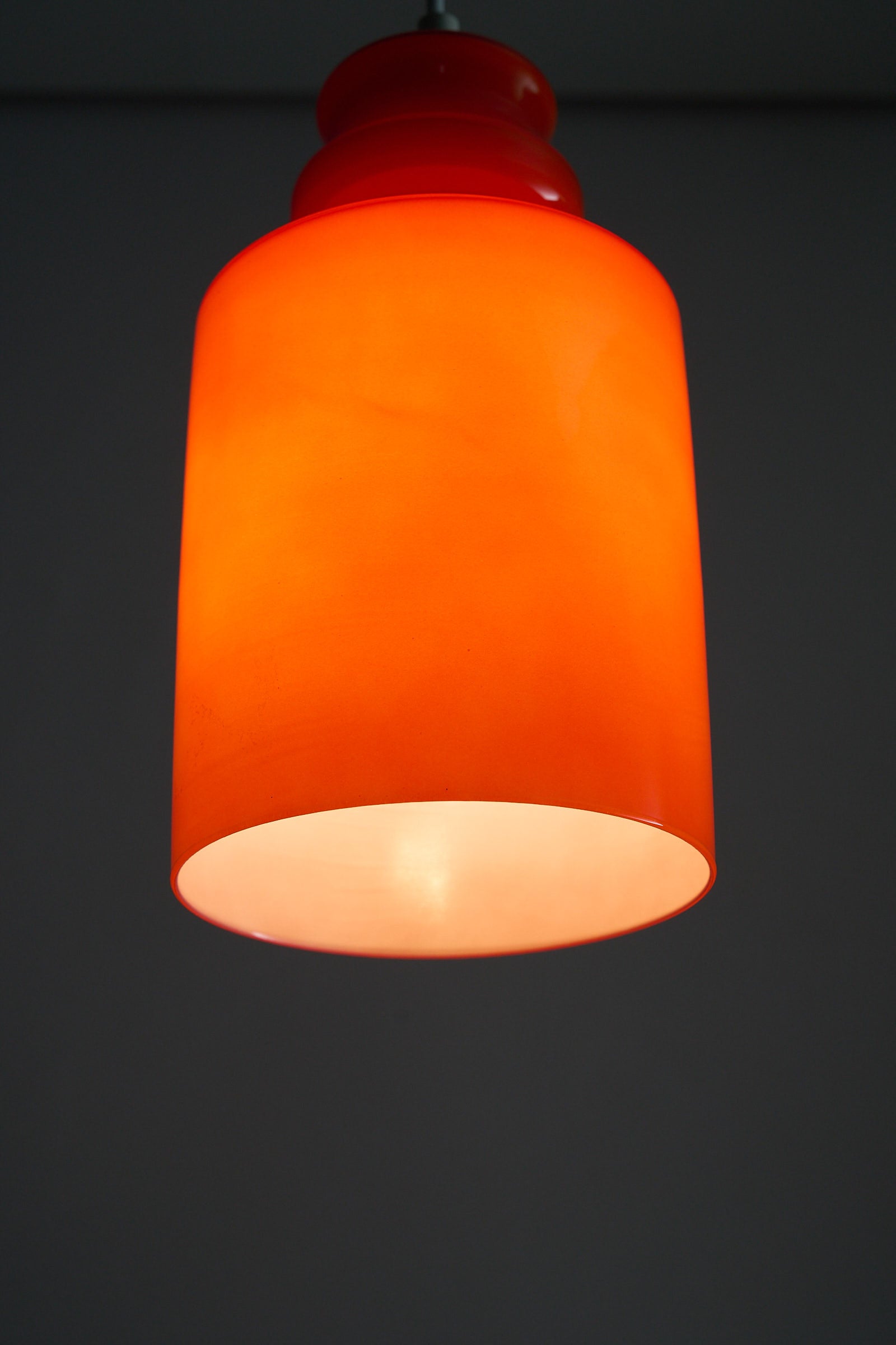 Orange Glass Pendant Lamp with glossy shade and warm tone, perfect for dining or reading areas.