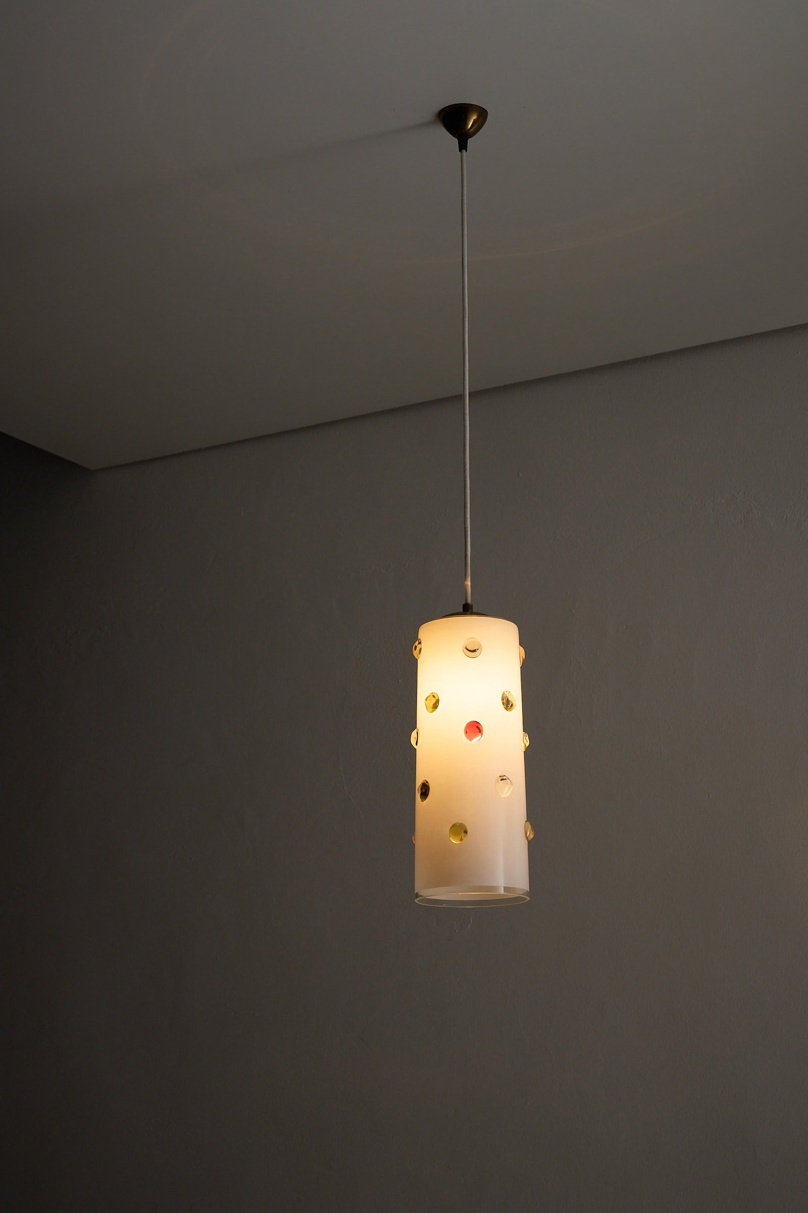 Vistosi Pendant Lamp With Colored Dots featuring satin white Murano glass and colorful dots in yellow, red, and blue.