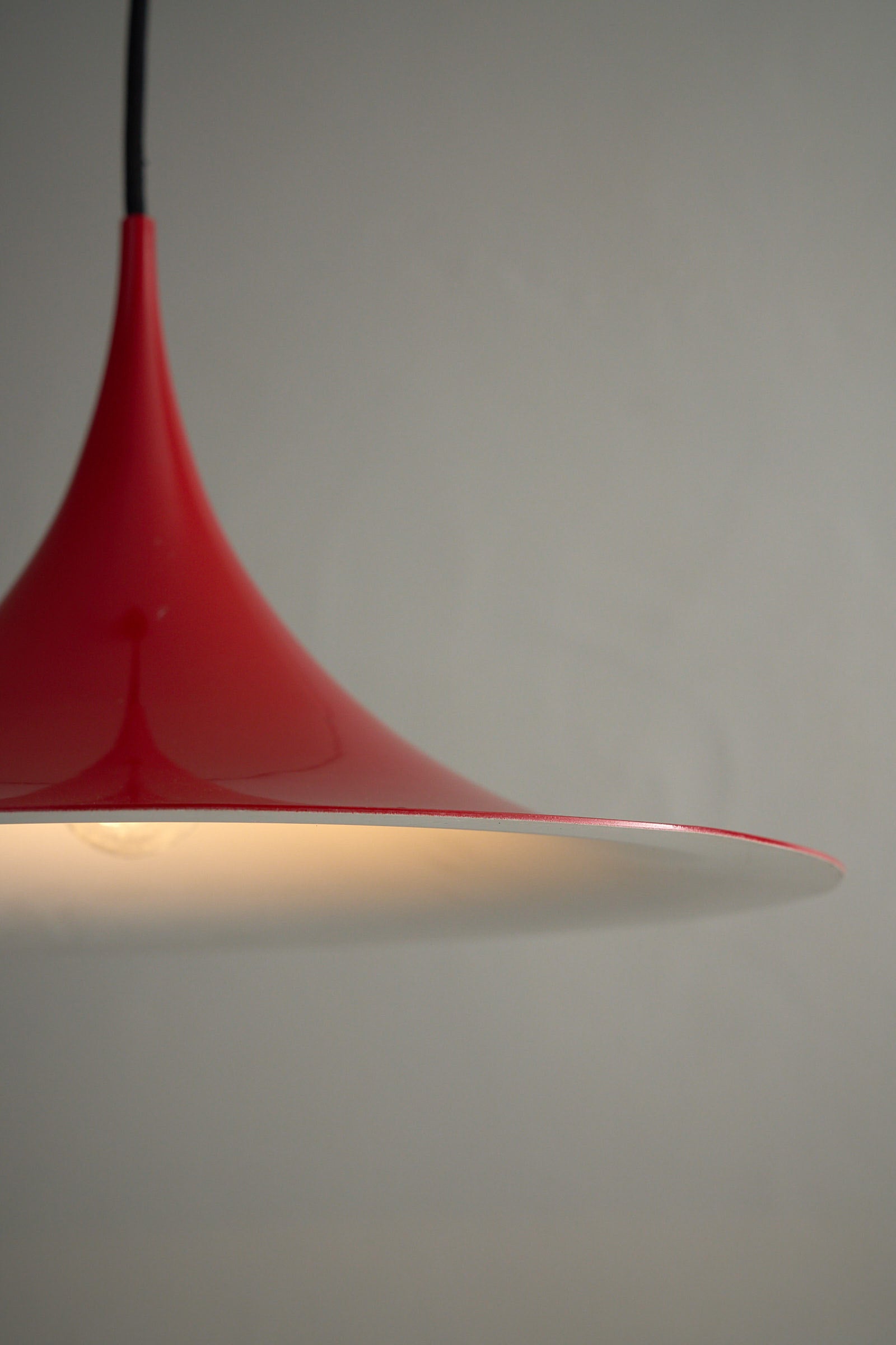 Fog&Mørup Red Semi Pendant Lamp showcasing its refined red enamel design and white interior for optimal light.