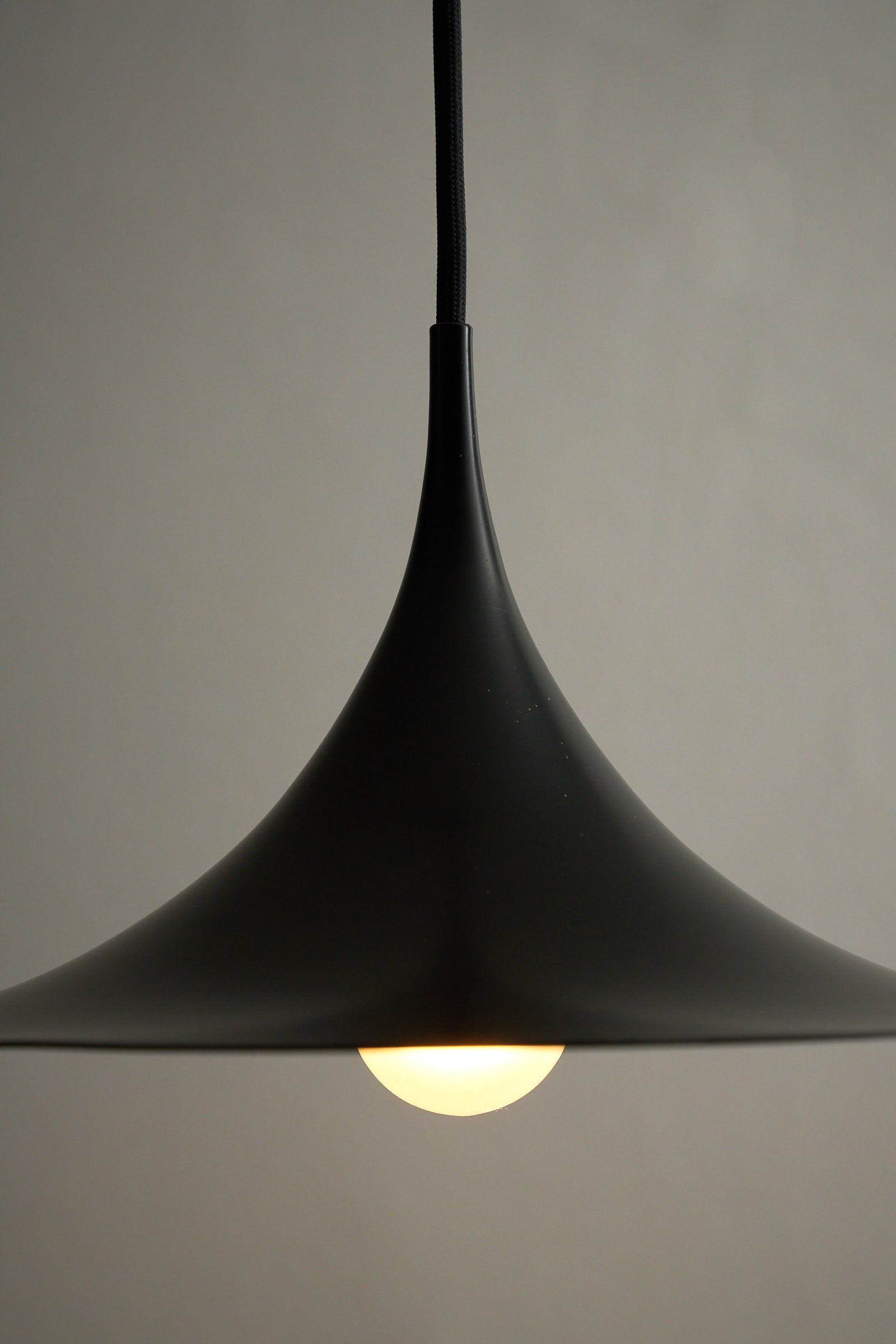 Small Fog & Mørup Black Semi Pendant Lamp with elegant shape and warm light illustration.