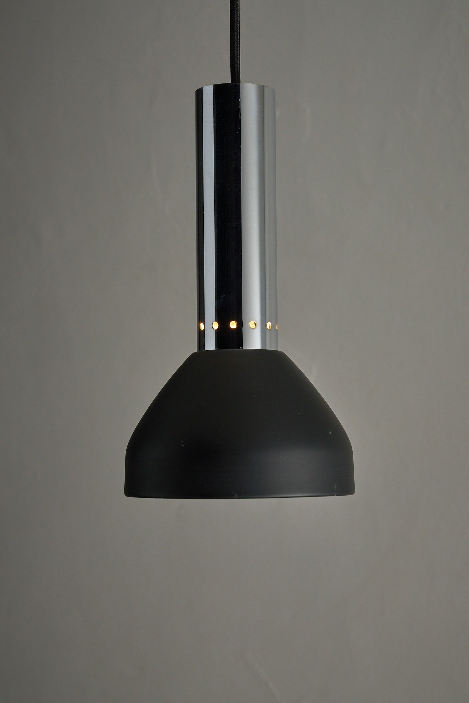 Chrome and Black Pendant Lamp with Perforated Detail, showcasing sleek design and elegant geometry.