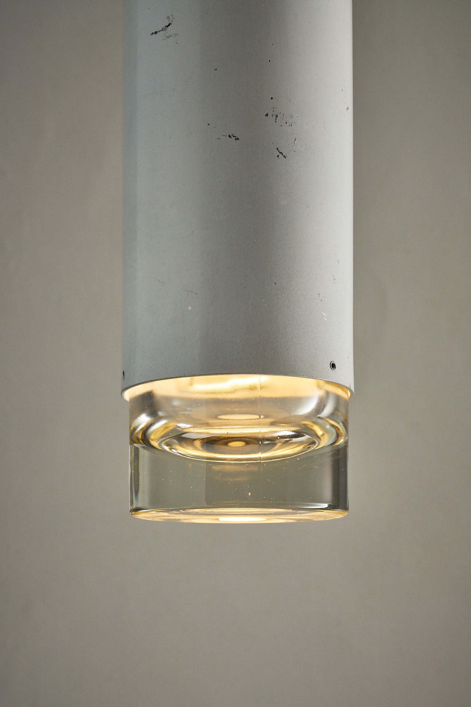 RAAK Amsterdam White Cylinder and Solid Glass Pendant Light featuring a white-painted cylinder and clear glass diffuser.
