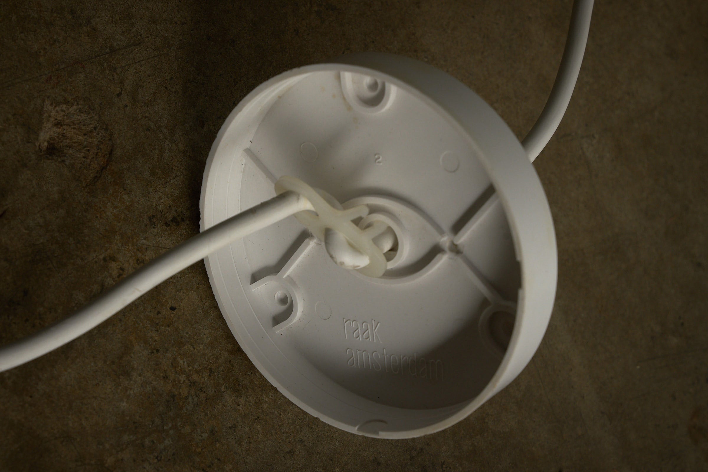 RAAK Amsterdam White Cylinder and Solid Glass Pendant Light mounting base with white cord.