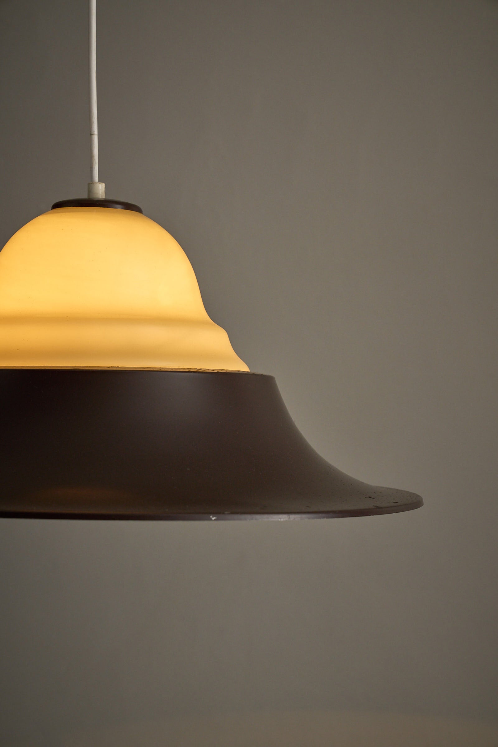 Mid-Century Modern Brown and Opaline Glass Layered Pendant showcasing amber opaline diffuser and brown metal shade.