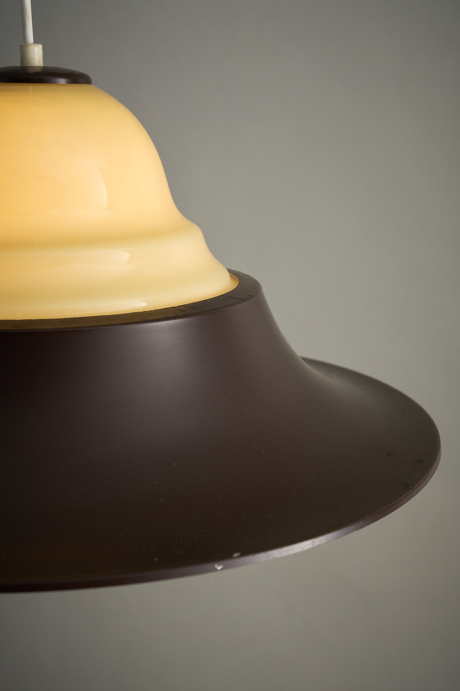 Mid-Century Modern Brown and Opaline Glass Layered Pendant lamp with amber opaline glass and dark brown metal shade.