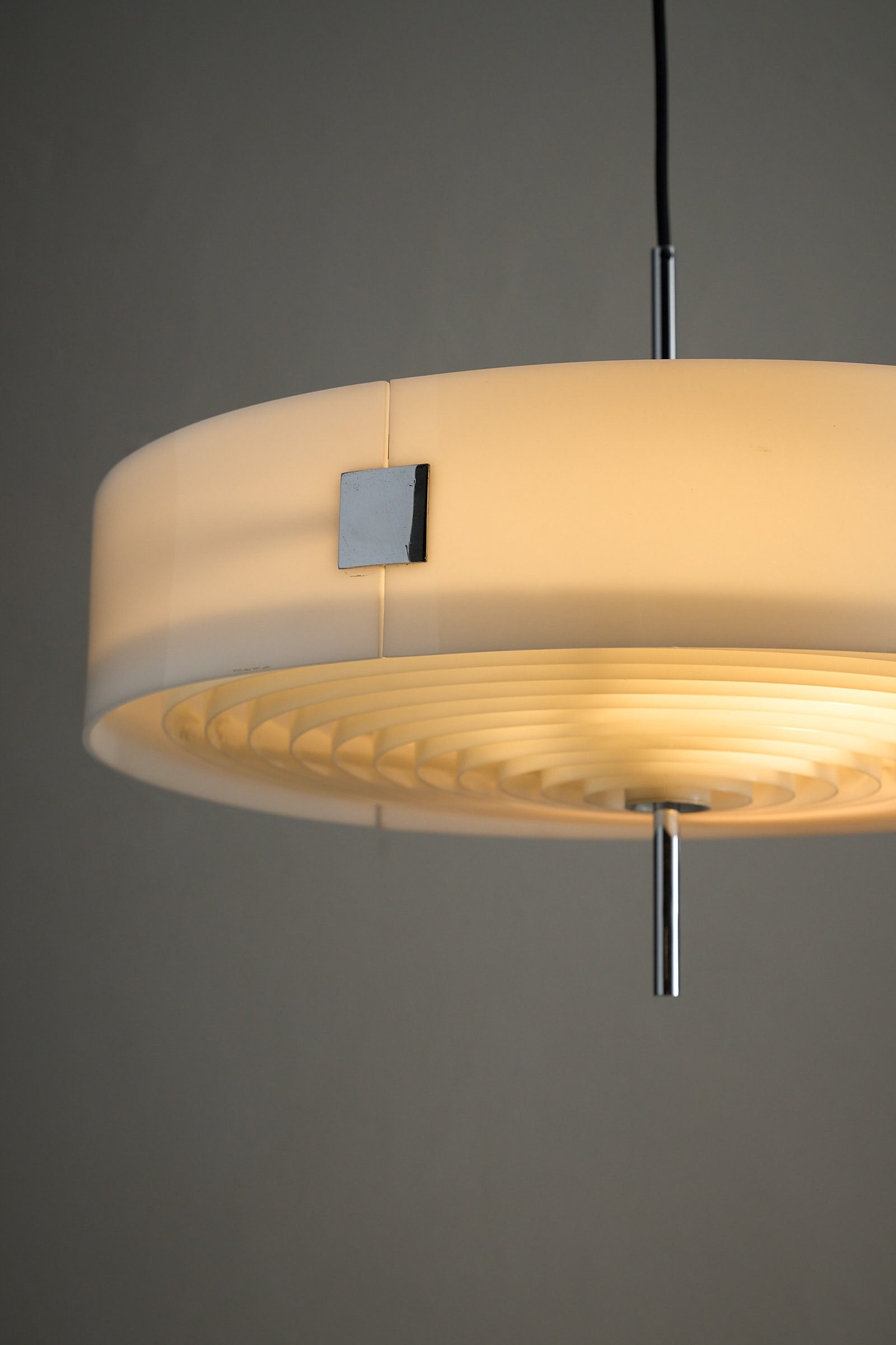 Cosack White Plexiglass Disc Pendant with Internal Grid, a modern pendant lamp with a sleek design.