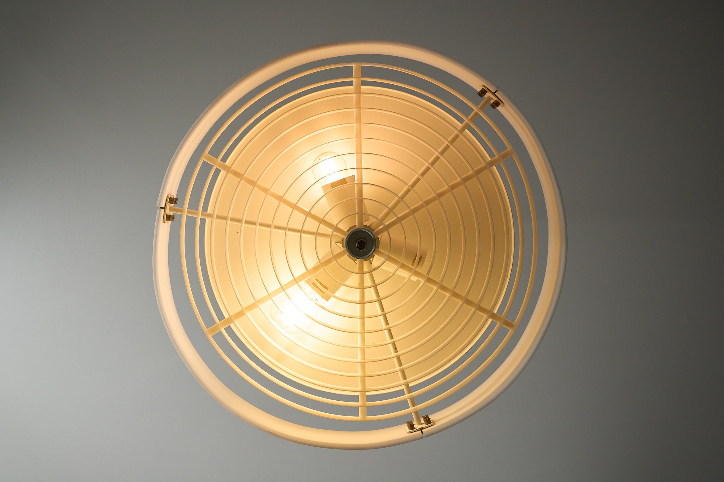 Cosack White Plexiglass Disc Pendant with Internal Grid viewed from below, showcasing its radial light louvre and design.
