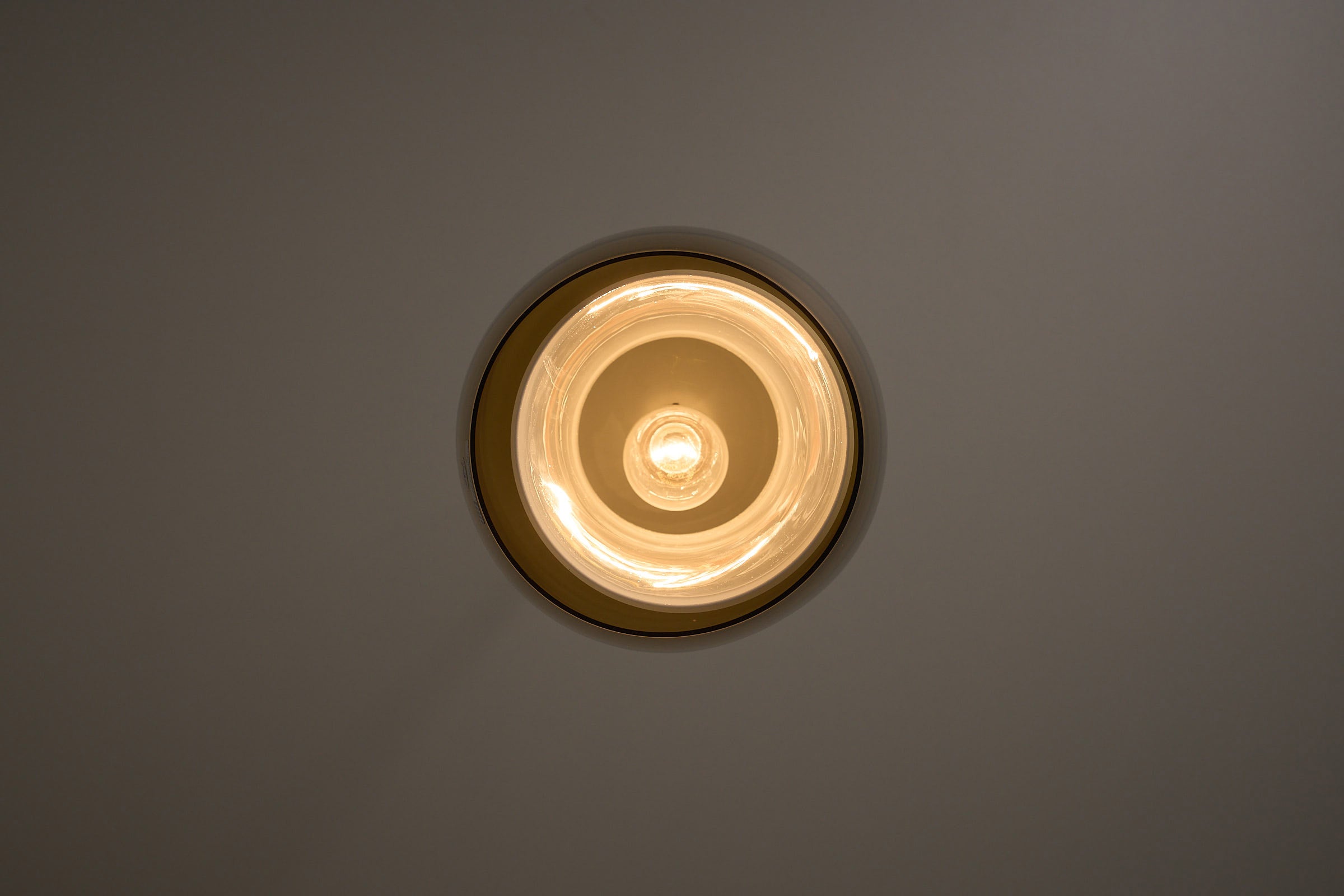Jo Hammerborg 'Radius' Pendant Lamp for Fog&Mørup viewed from below, showcasing its elegant design and warm lighting.