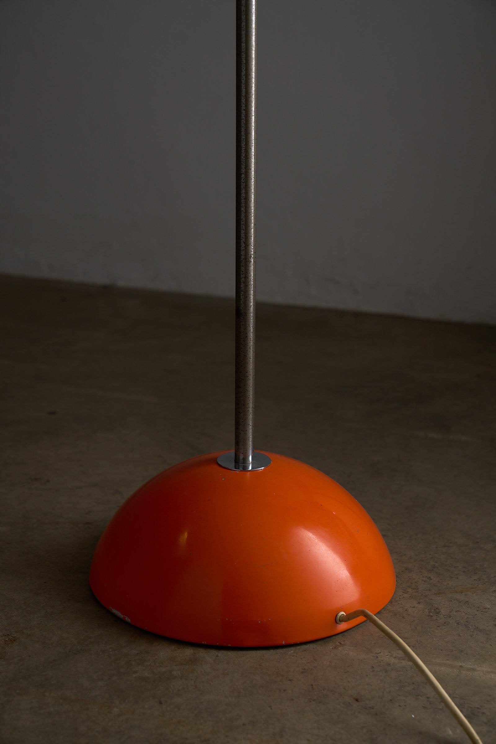 Orange Arc Floor Lamp by Cosack showing the vibrant orange half-sphere base and metal stem.