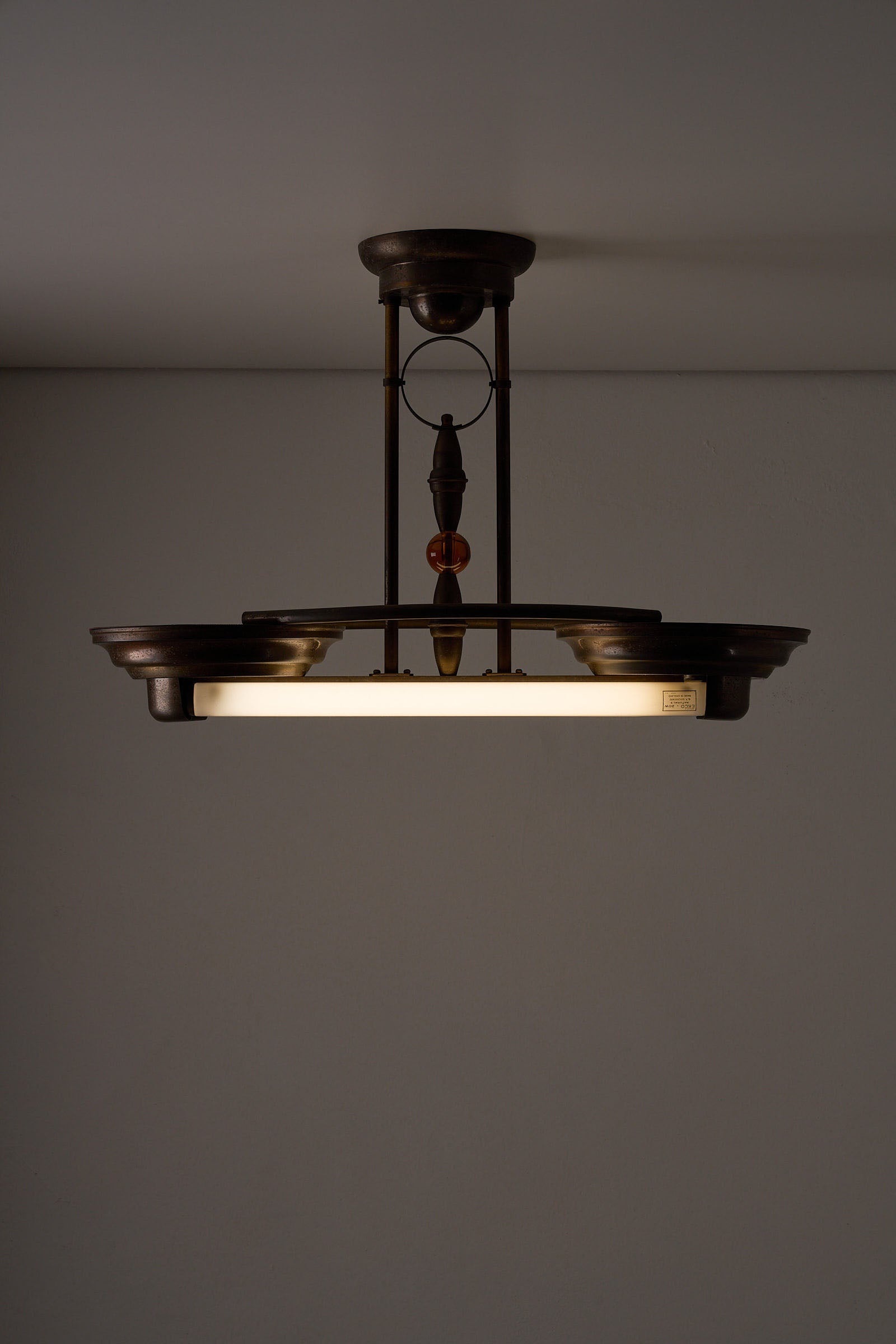 Antique Art Deco Double Fluorescent Ceiling Fixture in Patinated Bronze hanging from the ceiling.