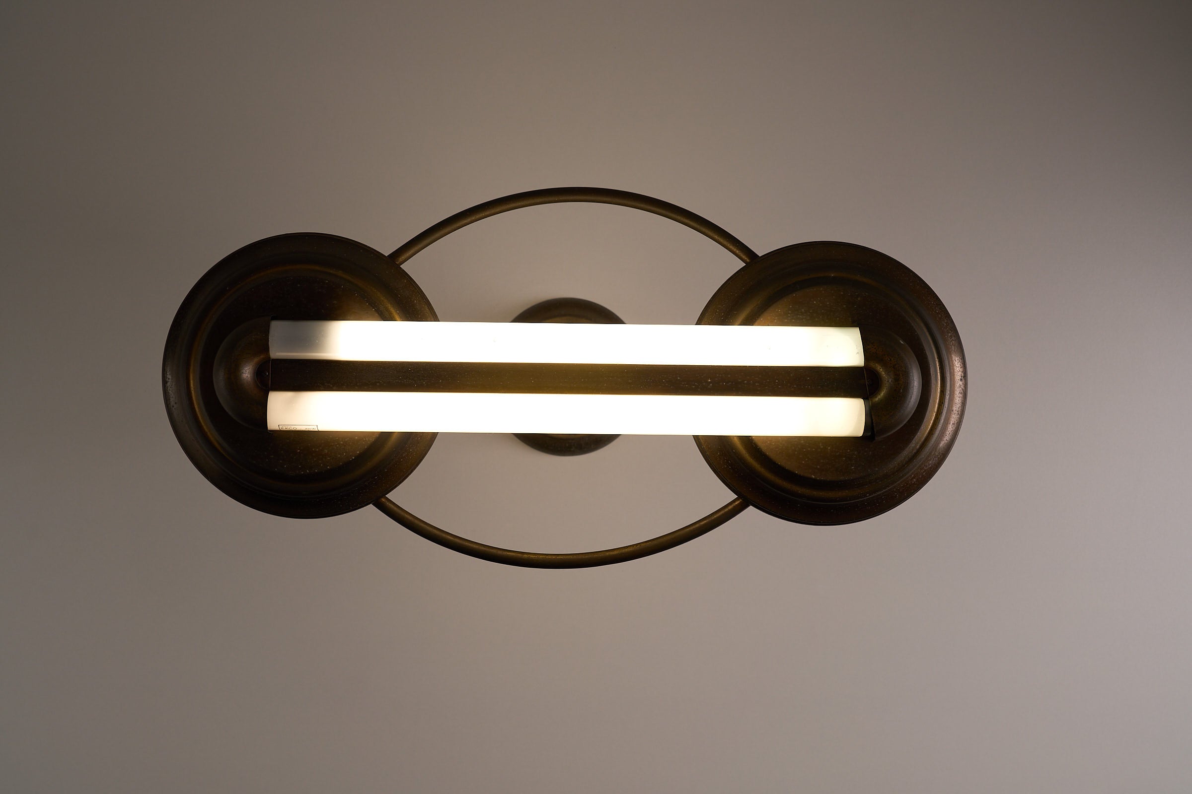 Antique Art Deco Double Fluorescent Ceiling Fixture in Patinated Bronze with amber glass bead accents and decorative end caps.