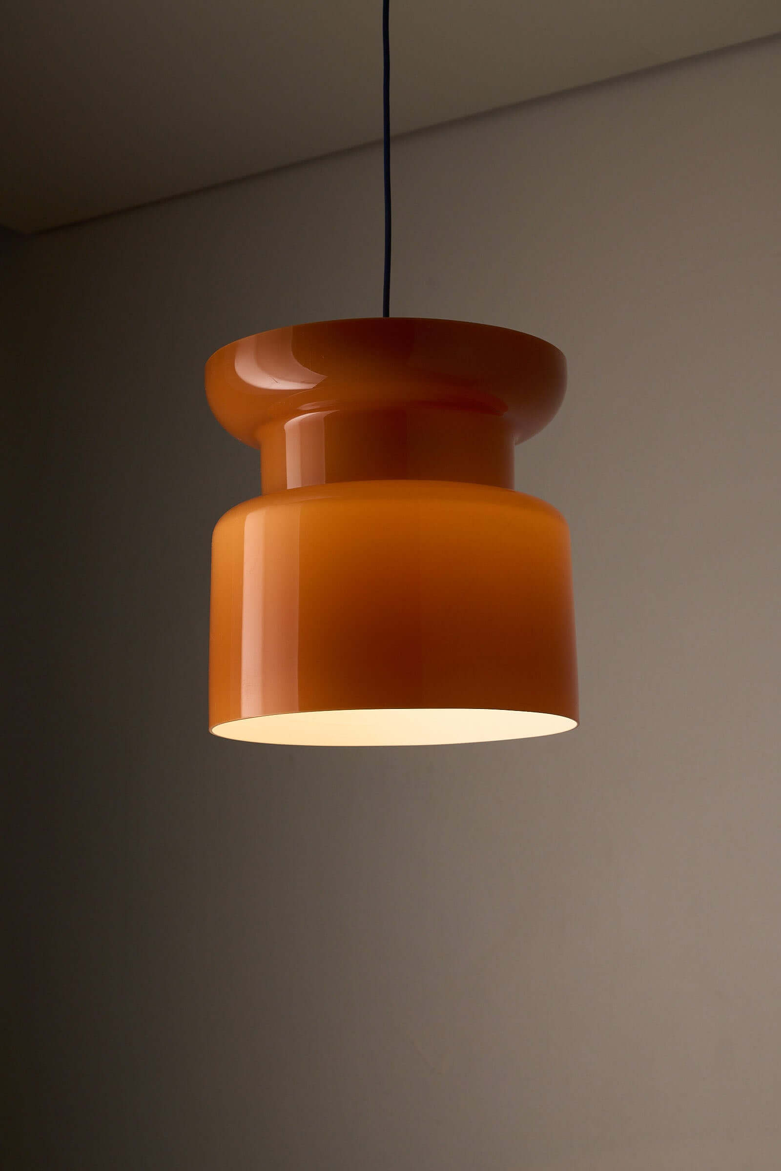 Translucent Orange Pendant with Dual Light Sources hanging lamp in a modern home setting.