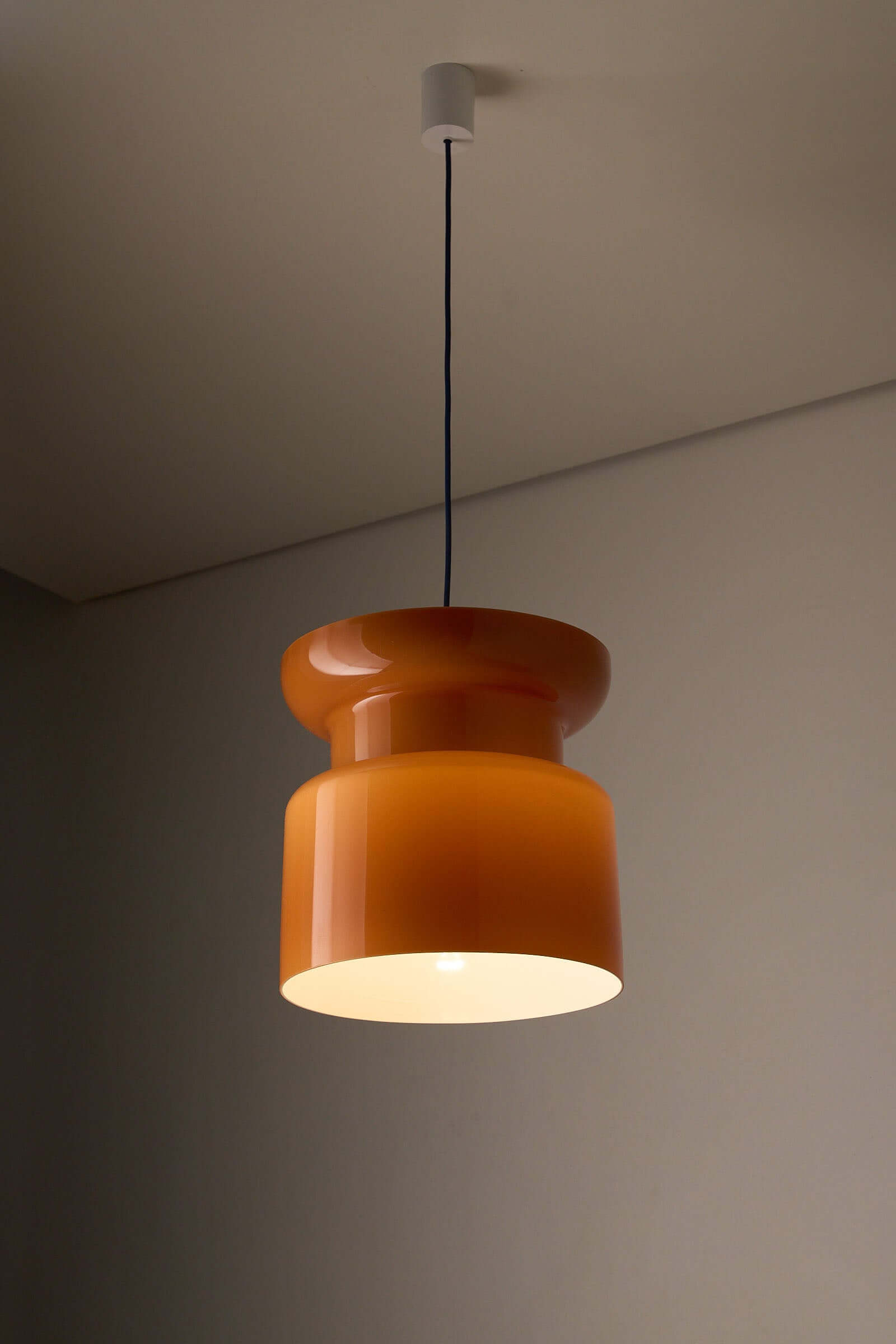 Translucent Orange Pendant with Dual Light Sources hanging lamp with an hourglass design, providing warm illumination.