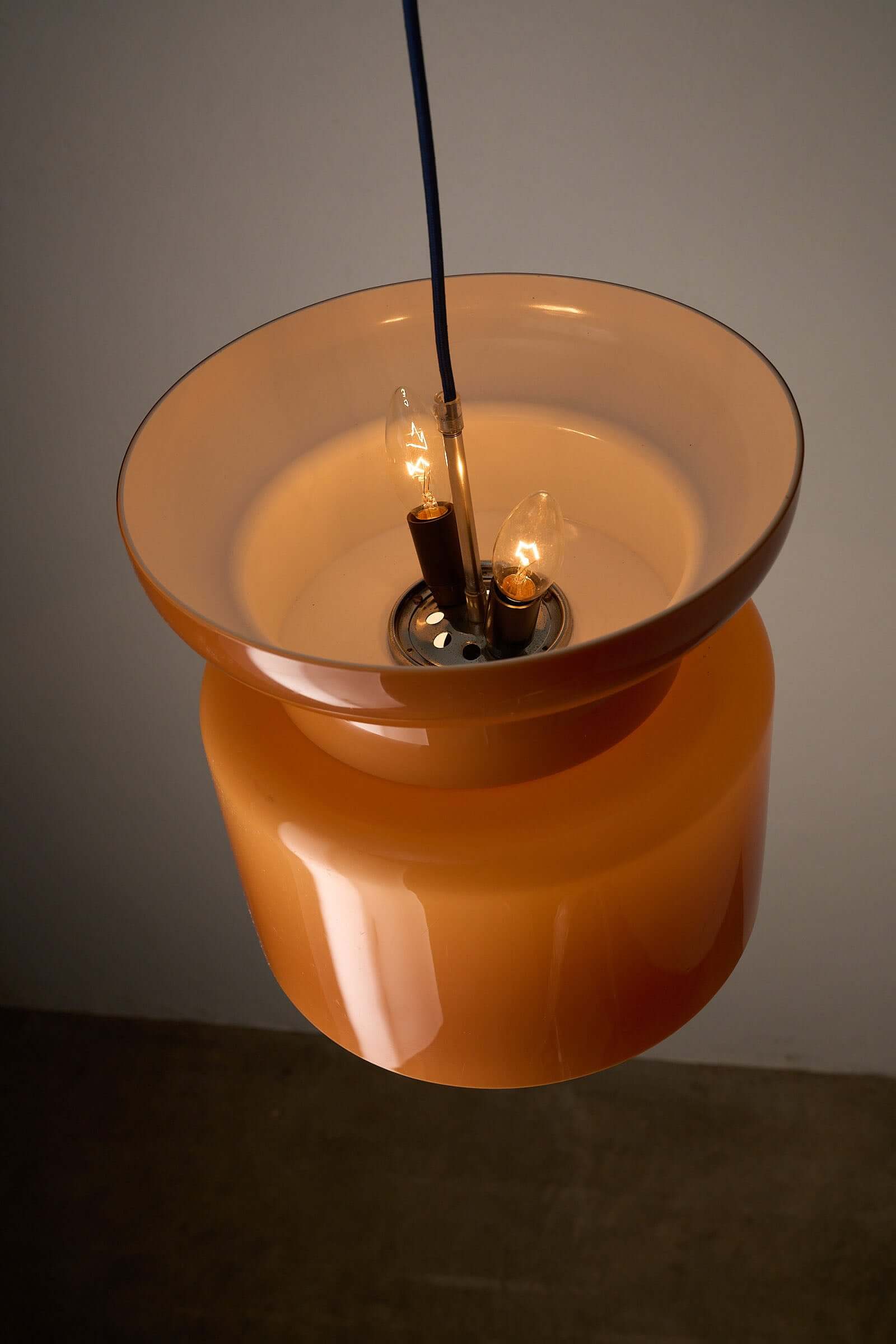 Translucent Orange Pendant with Dual Light Sources showcasing unique hourglass design and dual lighting features.