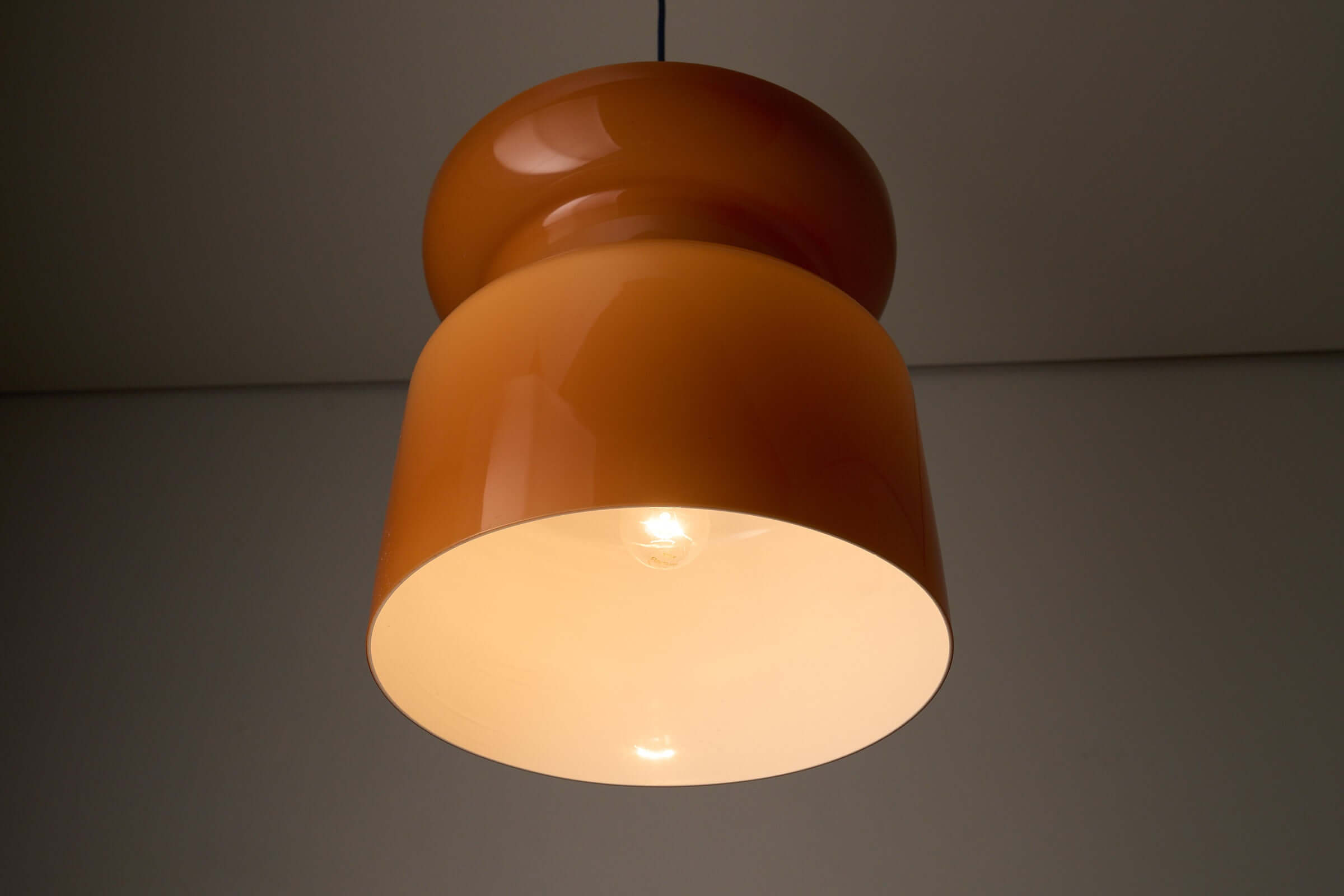 Translucent Orange Pendant with Dual Light Sources, featuring elegant hourglass design and dual lighting.