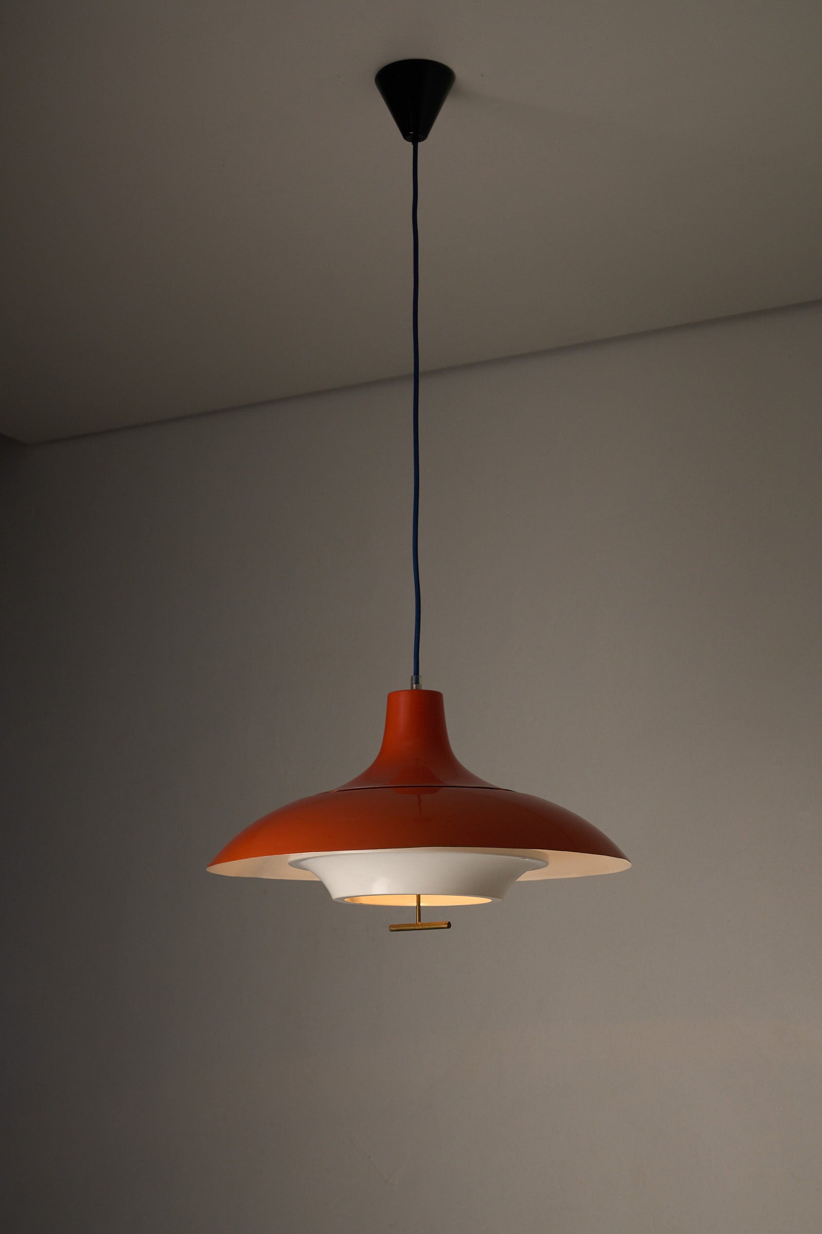 1960s Orange Pendant with Brass Detail hanging lamp featuring a high-gloss orange exterior and matte white interior.