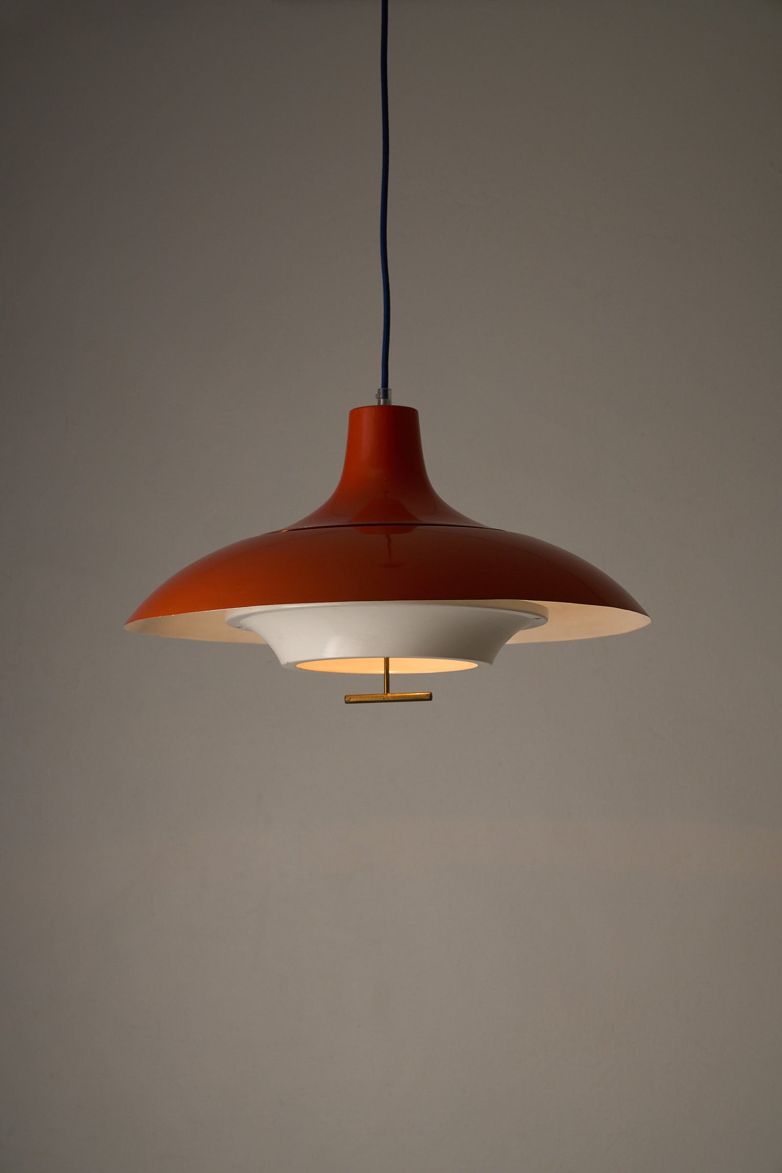 1960s Orange Pendant with Brass Detail featuring a gloss orange shade and a matte white interior.