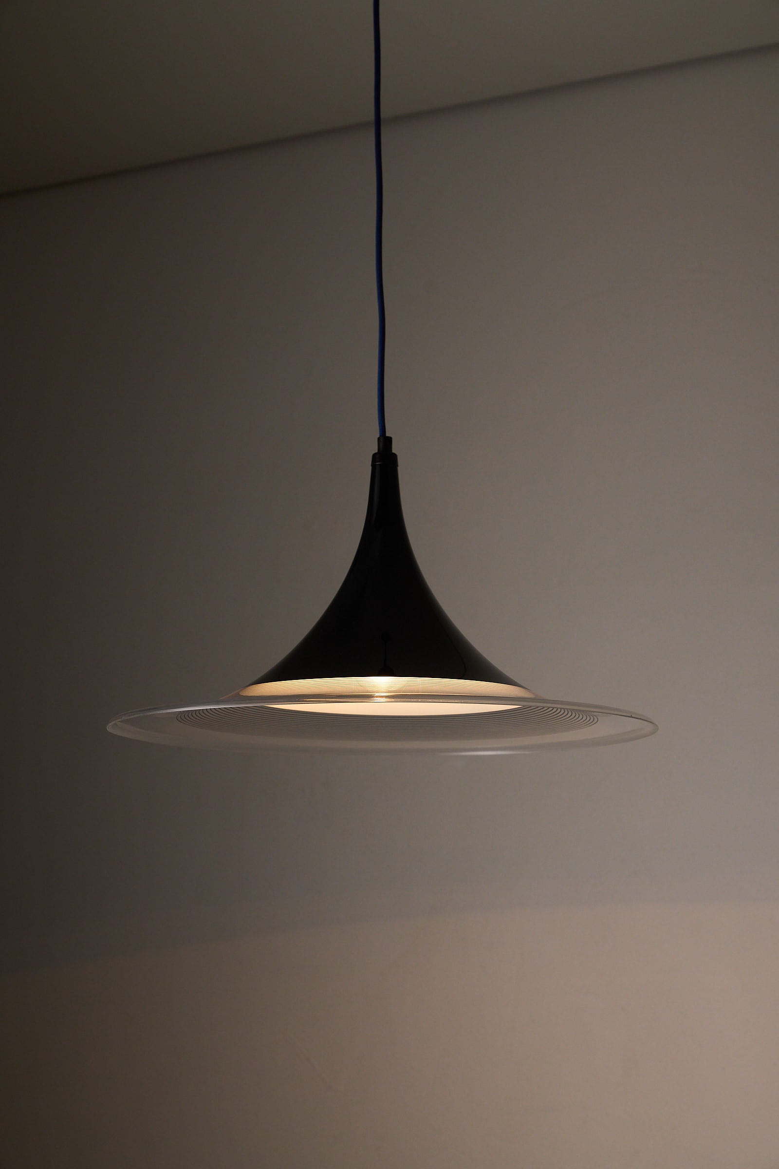 Black and Clear Acrylic Pendant lamp with a sleek concave design, perfect for dining areas.