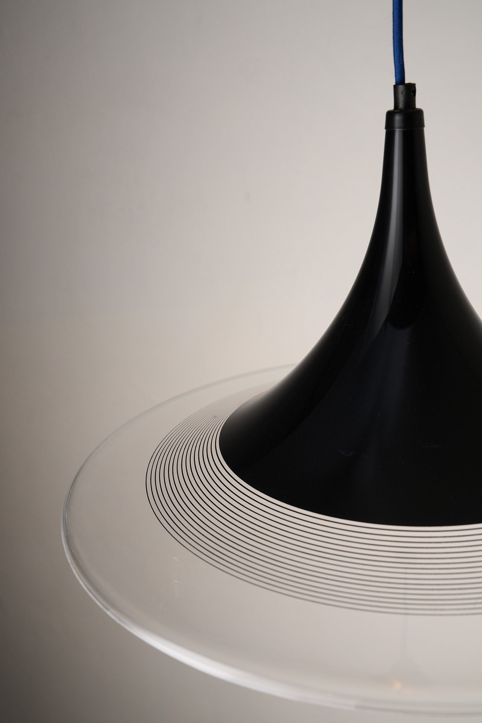 Black and Clear Acrylic Pendant featuring a conical silhouette with graphic lines and clear base.