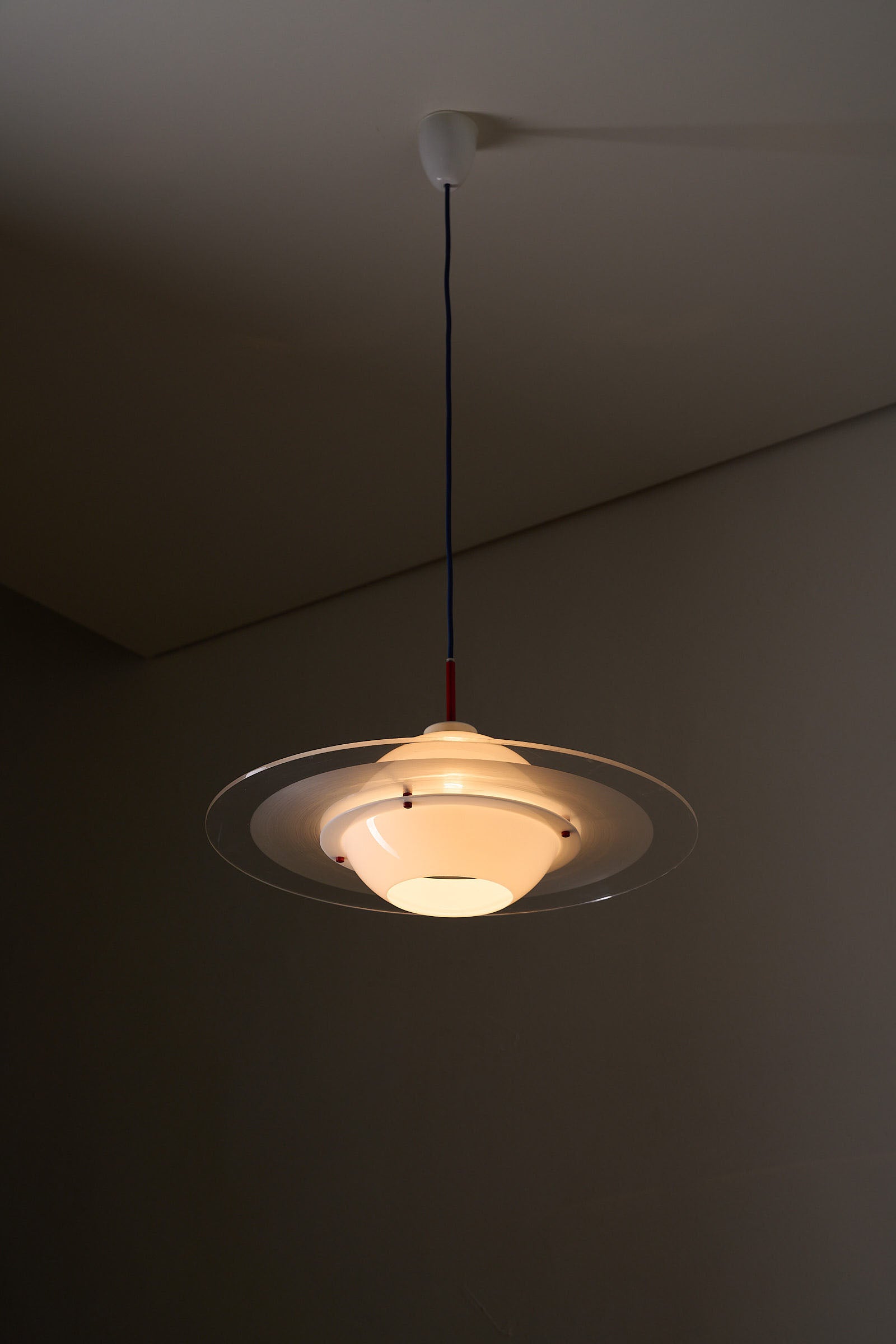 Space Age 'Saturn' Plexiglass Pendant Lamp with Red Details hanging from the ceiling, showcasing its iconic design.