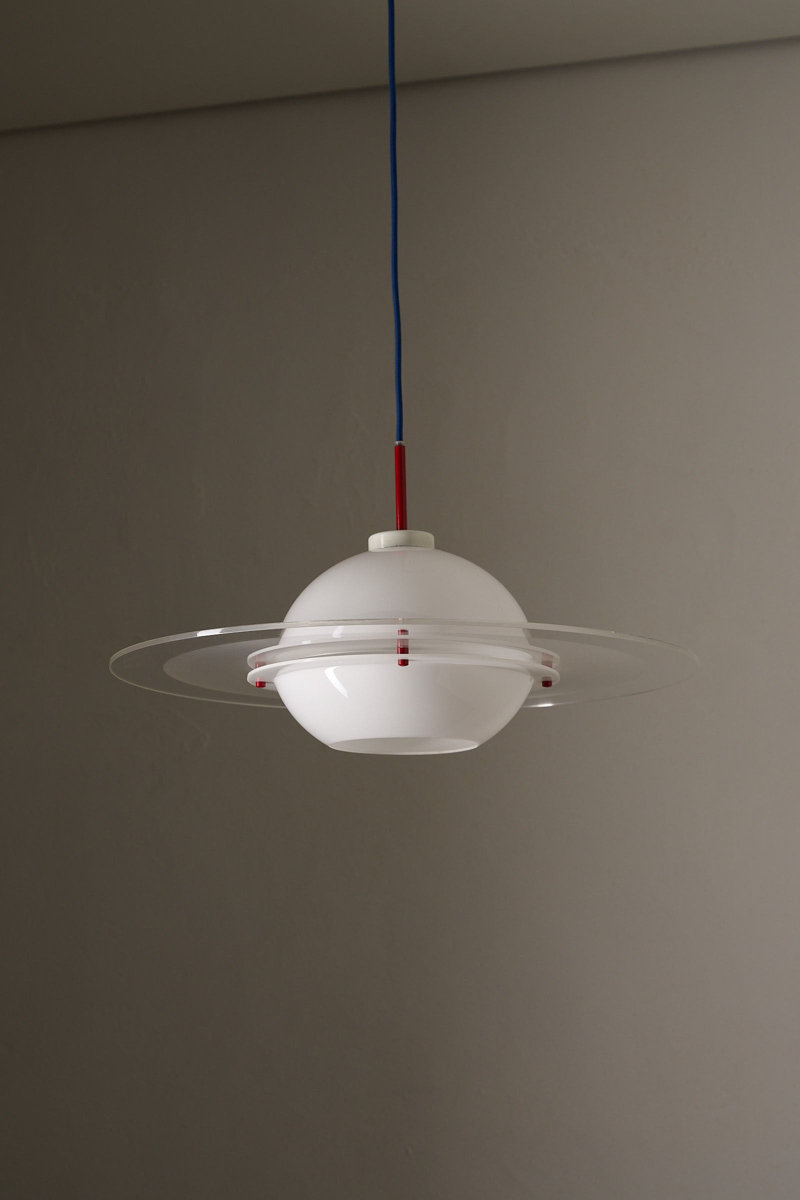 Space Age 'Saturn' Plexiglass Pendant Lamp with Red Details hanging in a modern interior, showcasing its unique design.
