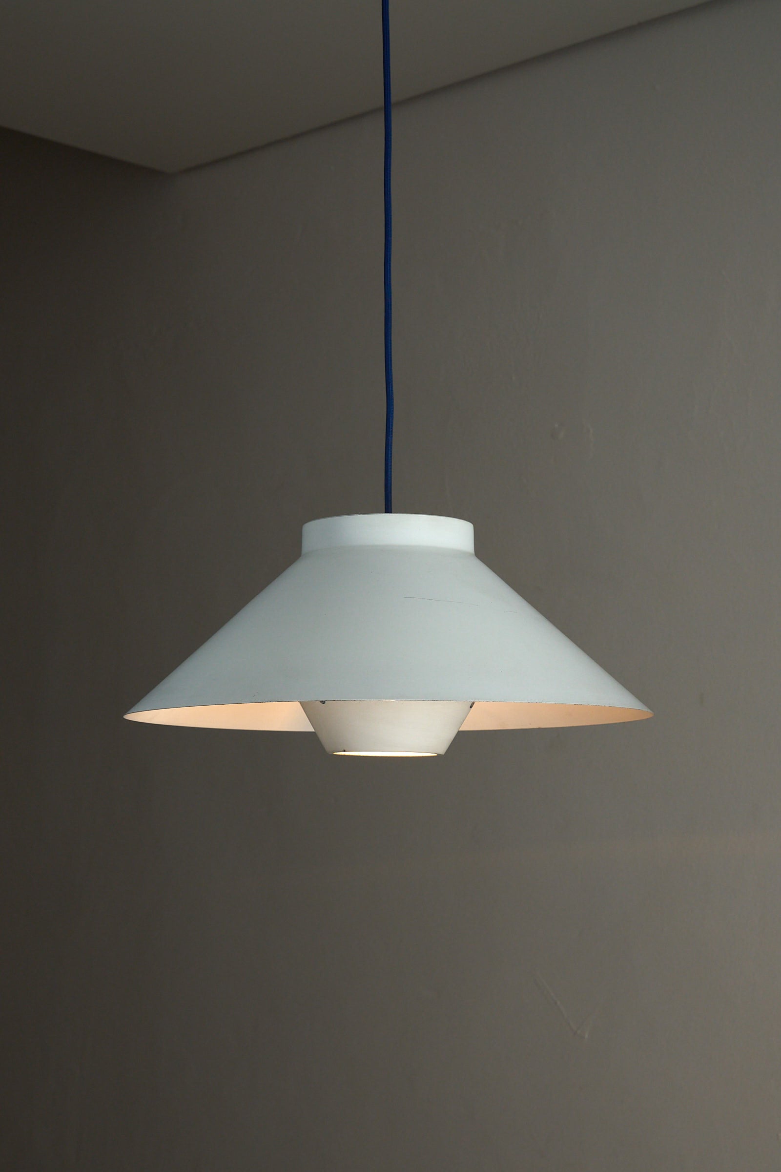 1960s Functionalist Layered Pendant Lamp in Matte White hanging from the ceiling, showcasing its classic Scandinavian design.