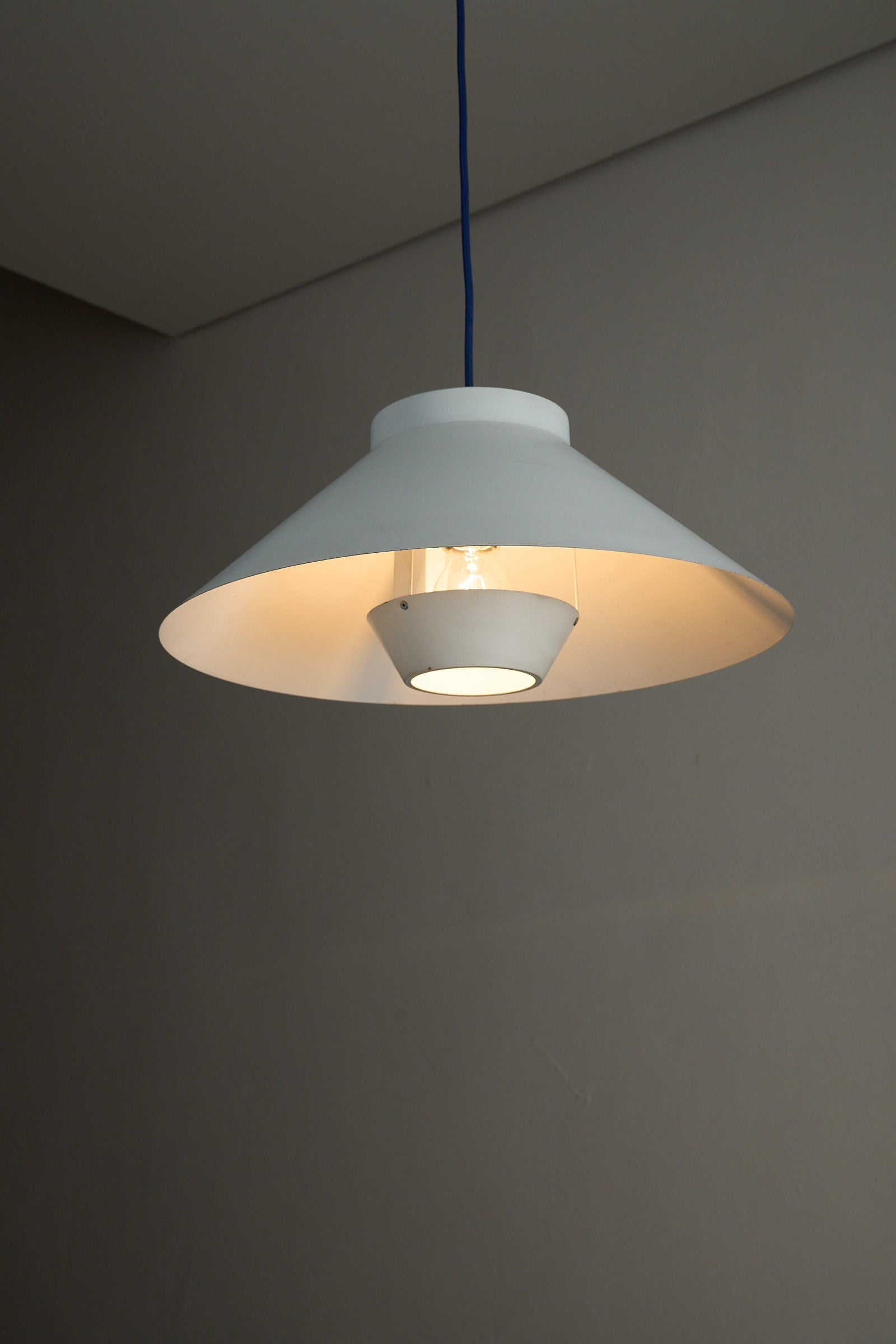 1960s Functionalist Layered Pendant Lamp in Matte White illuminating a room with stylish Scandinavian design.