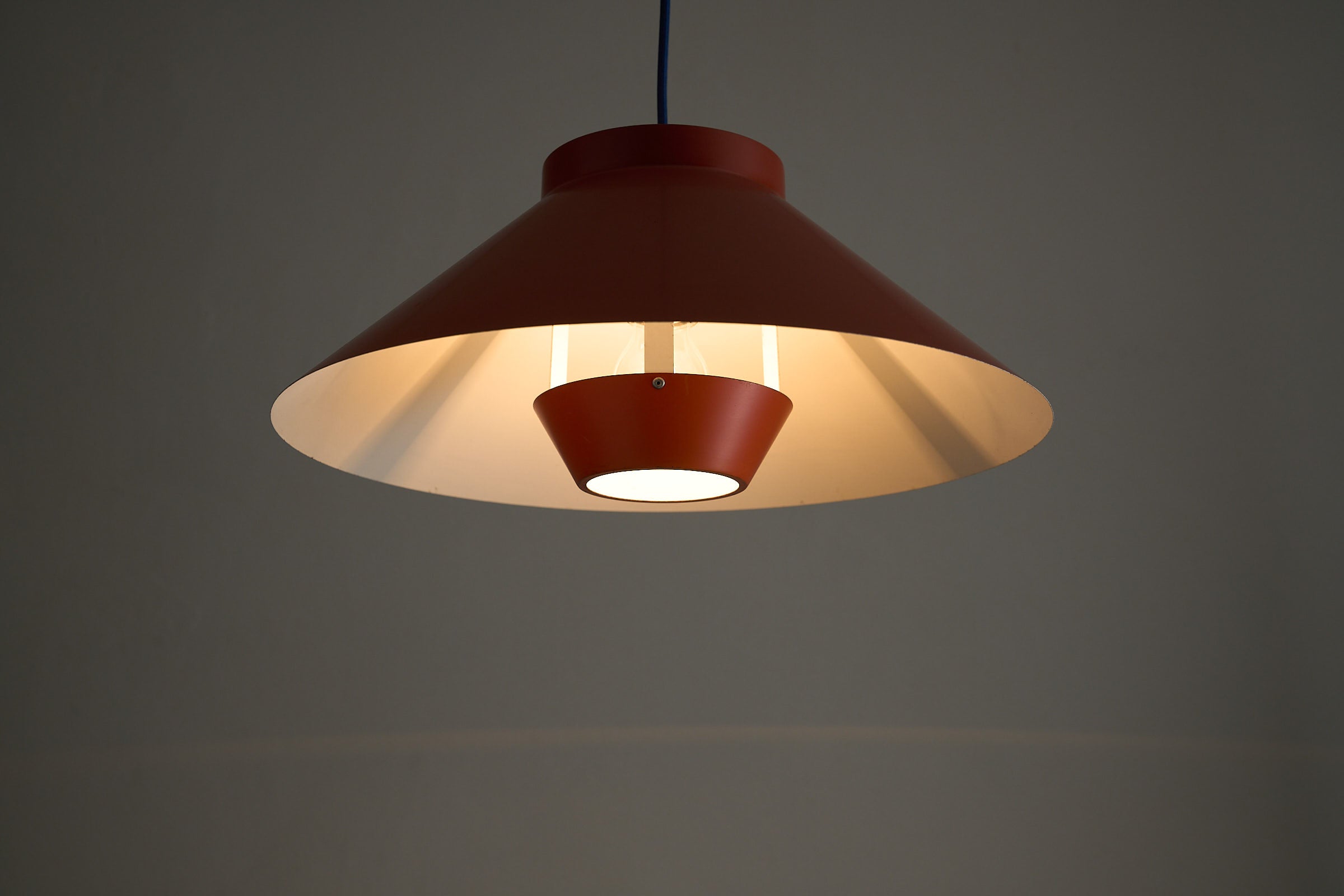 1960s Functionalist Layered Pendant Lamp in Stone Red featuring a wide conical shade and recessed inner glare shield.