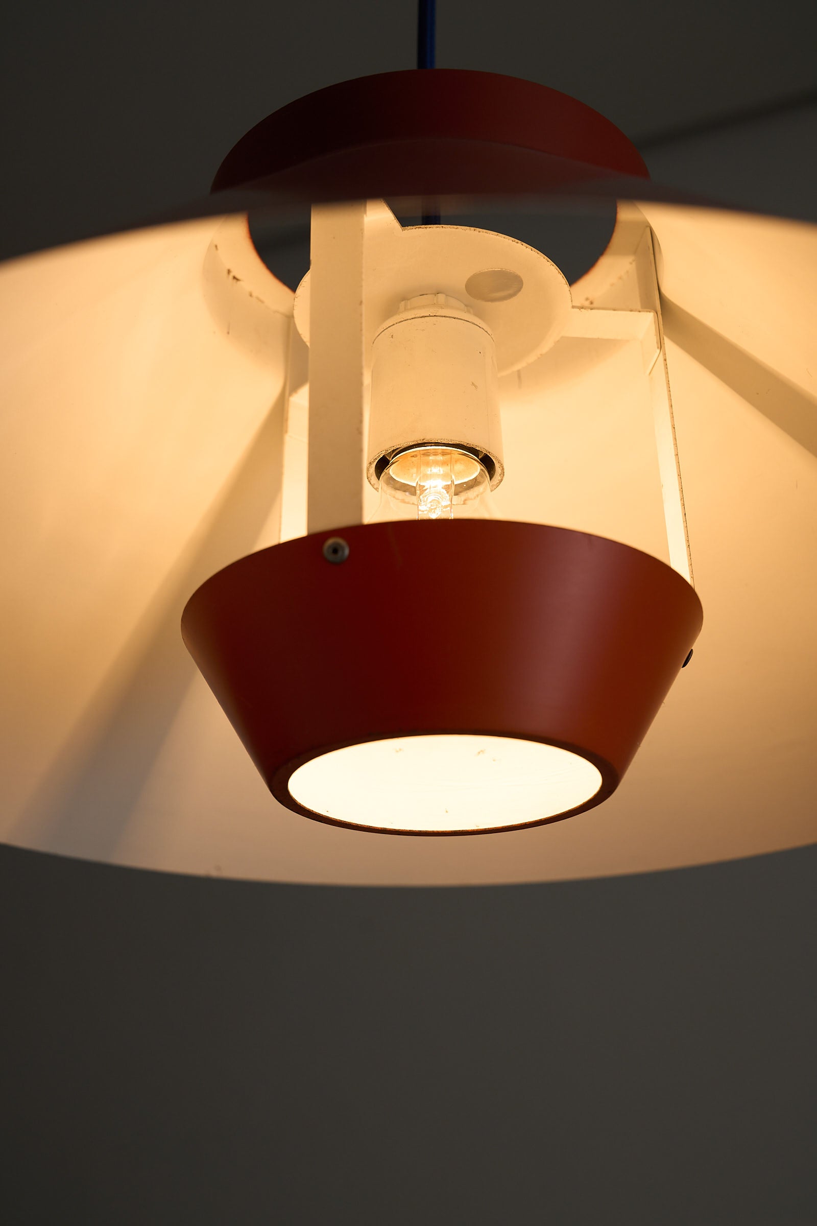 1960s Functionalist Layered Pendant Lamp in Stone Red showcasing a conical shade and internal glare shield.