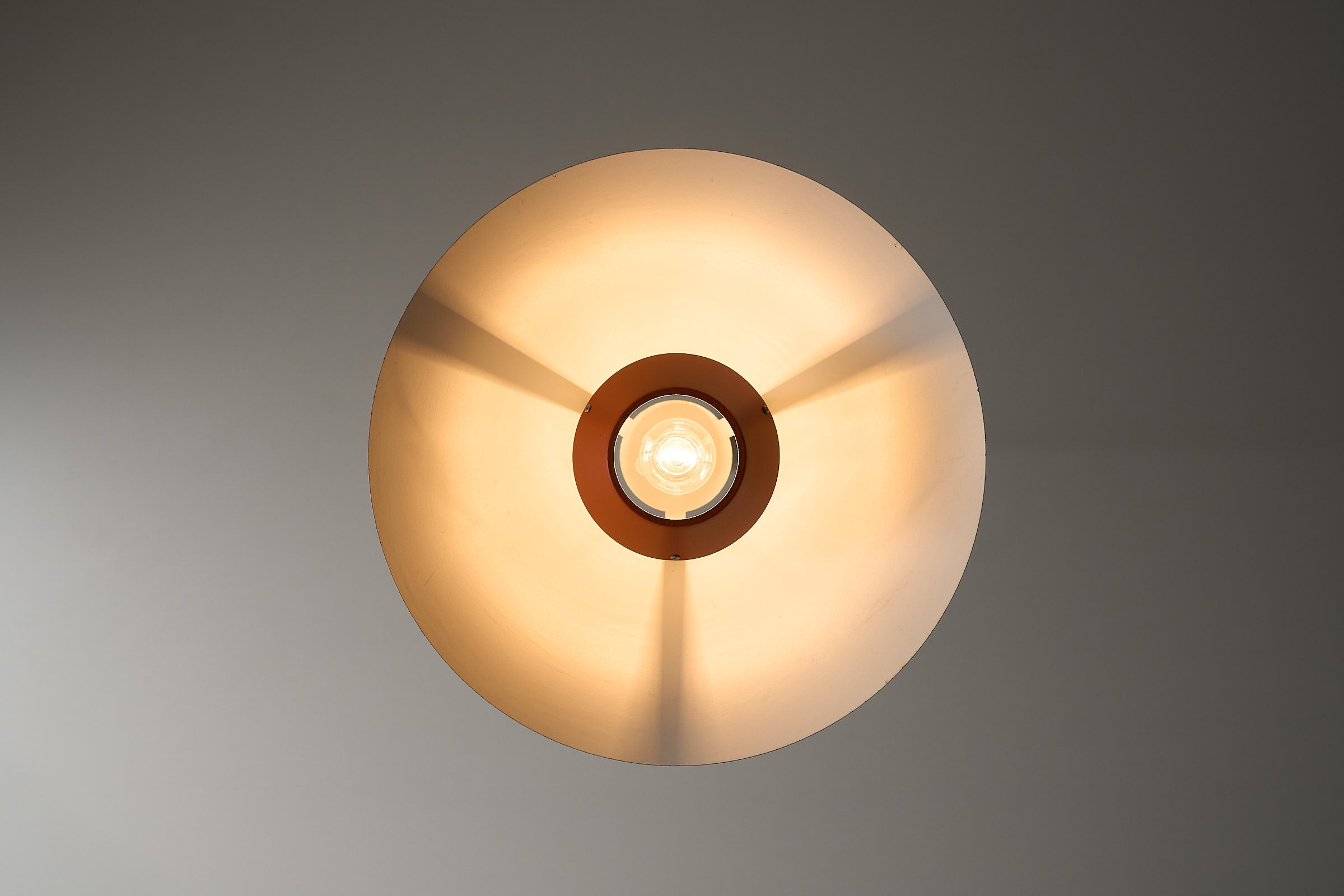 1960s Functionalist Layered Pendant Lamp in Stone Red viewed from above, showcasing its wide conical shape and exposed bulb.