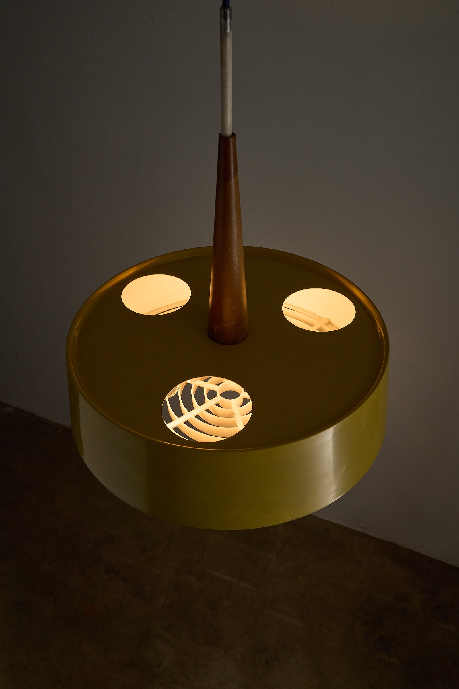 Pendant Lamp in Yellow with Teak Accent featuring a wide yellow shade and warm teak wood stem.