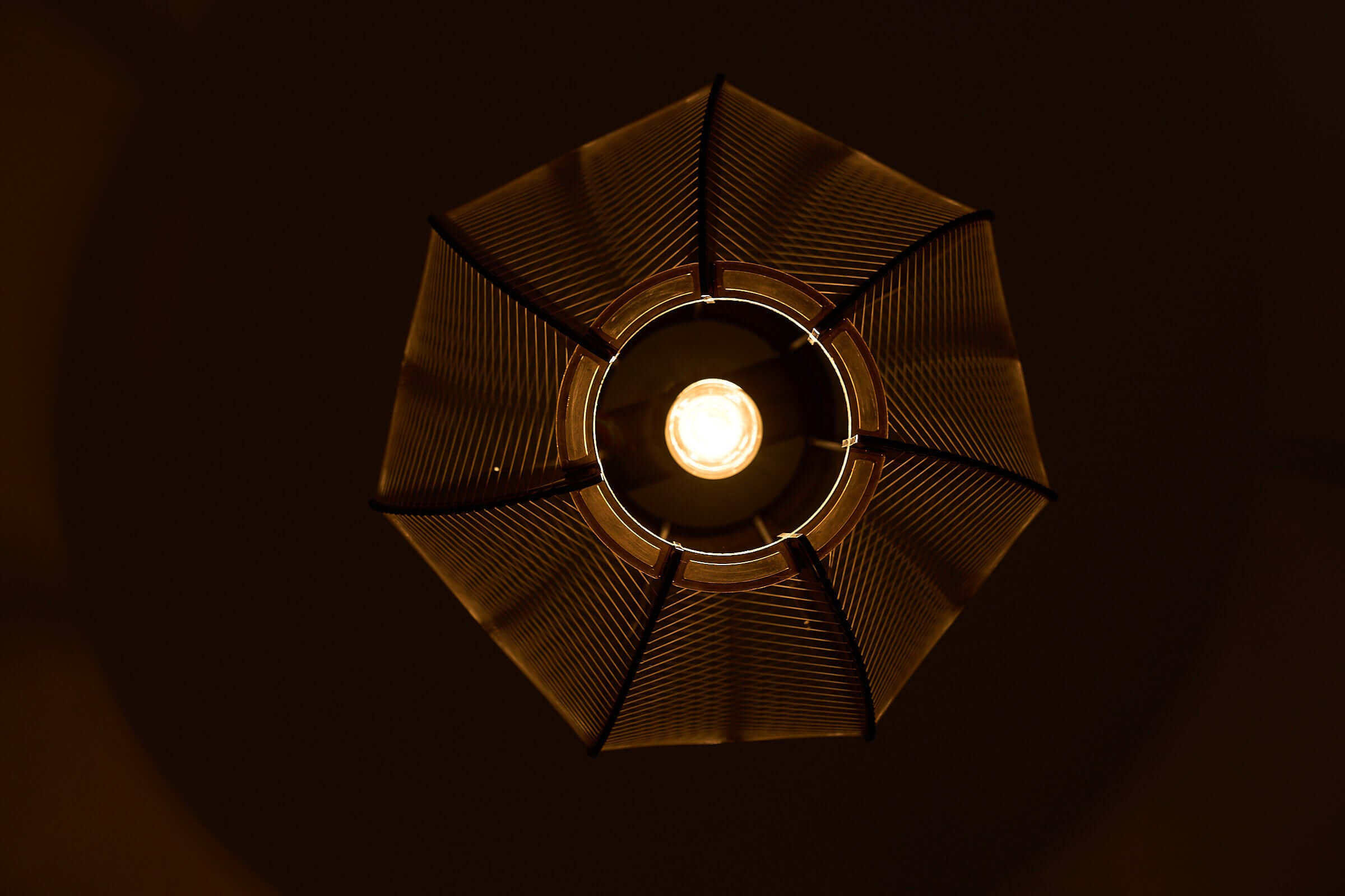 Paul Secon String Art Pendant Lamp viewed from below, showcasing interlocking segments and fine nylon strings.