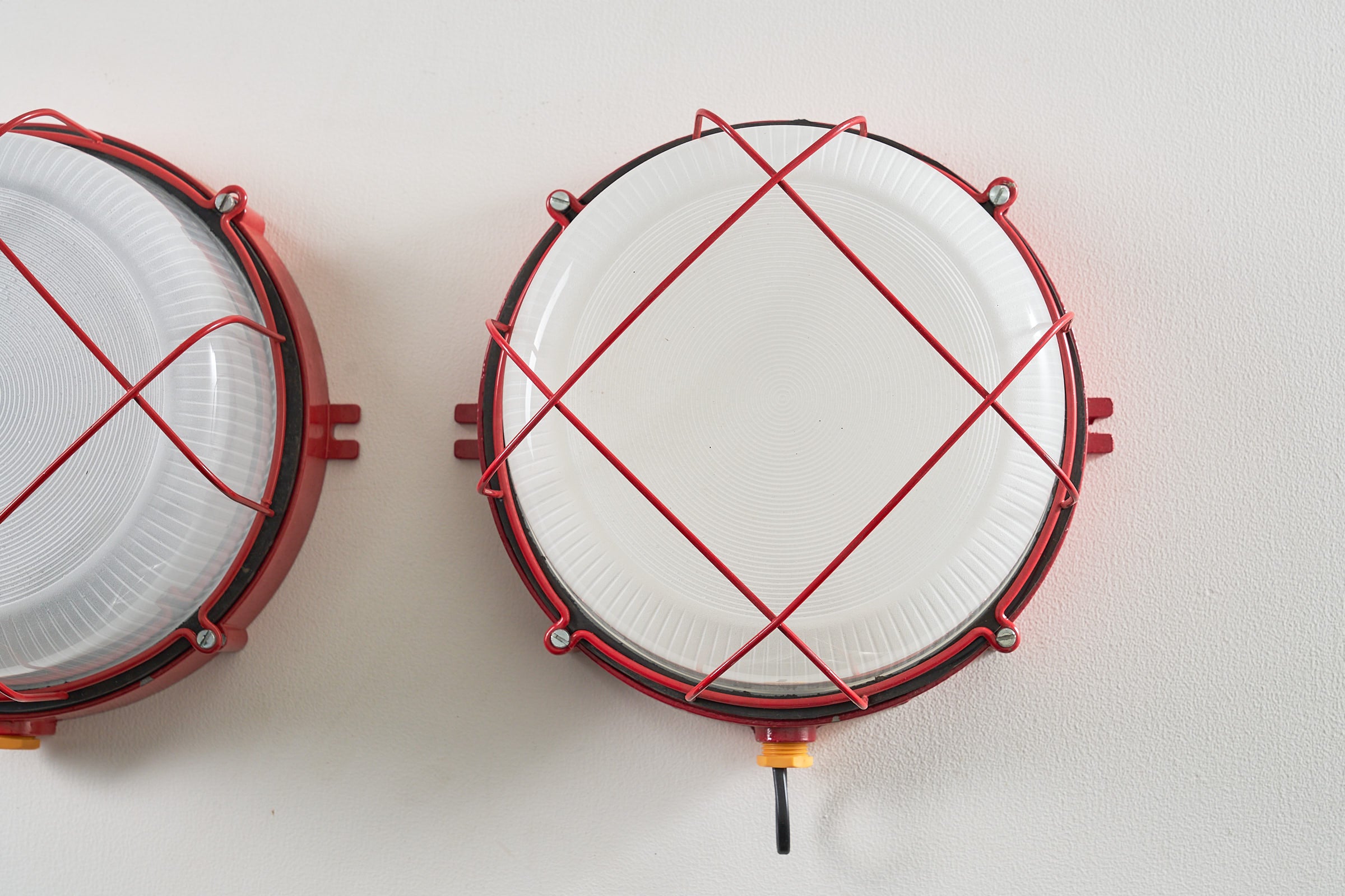 Pair of Red Marine Cage Lamps (set) featuring vintage industrial design and red enameled finish.