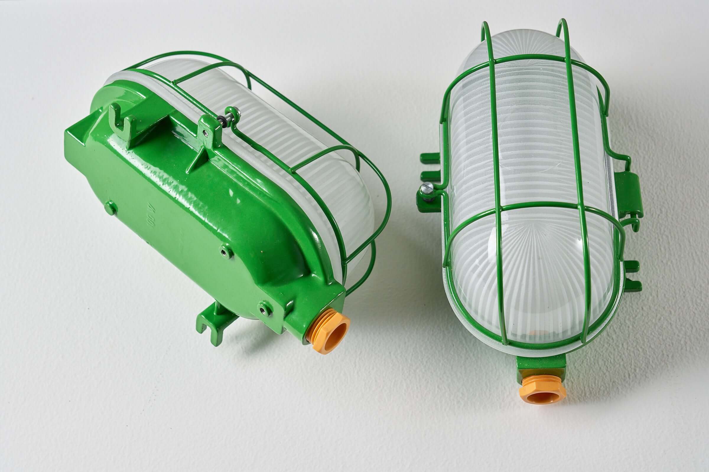 Set of 2 Industrial Oval Bright Green Cage Lamp featuring durable green enamel finish and protective wire cage.