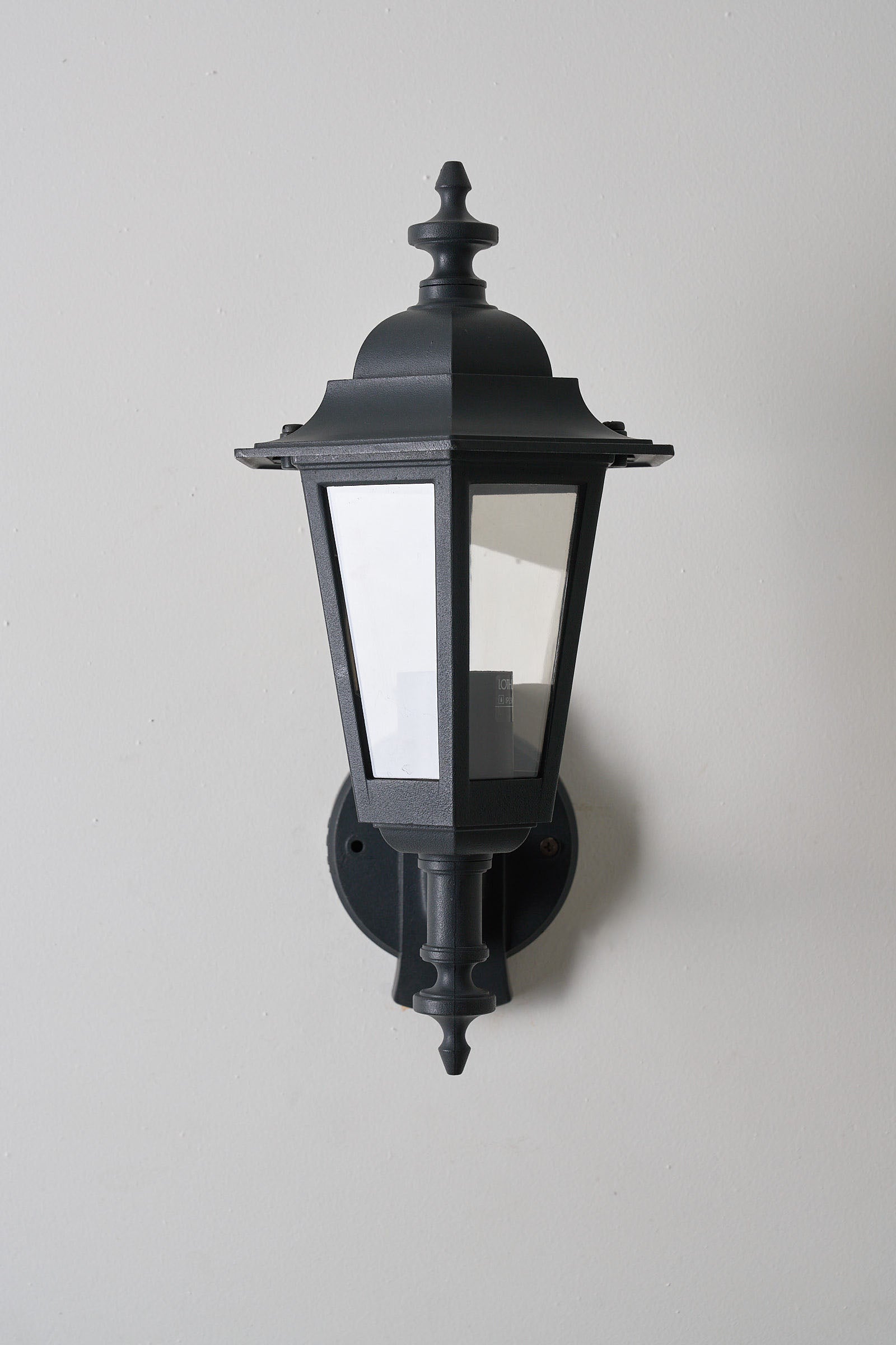 Pair of Traditional Outdoor Wall Lamps by Lothus (set) featuring clear glass lantern and curved bracket arm.