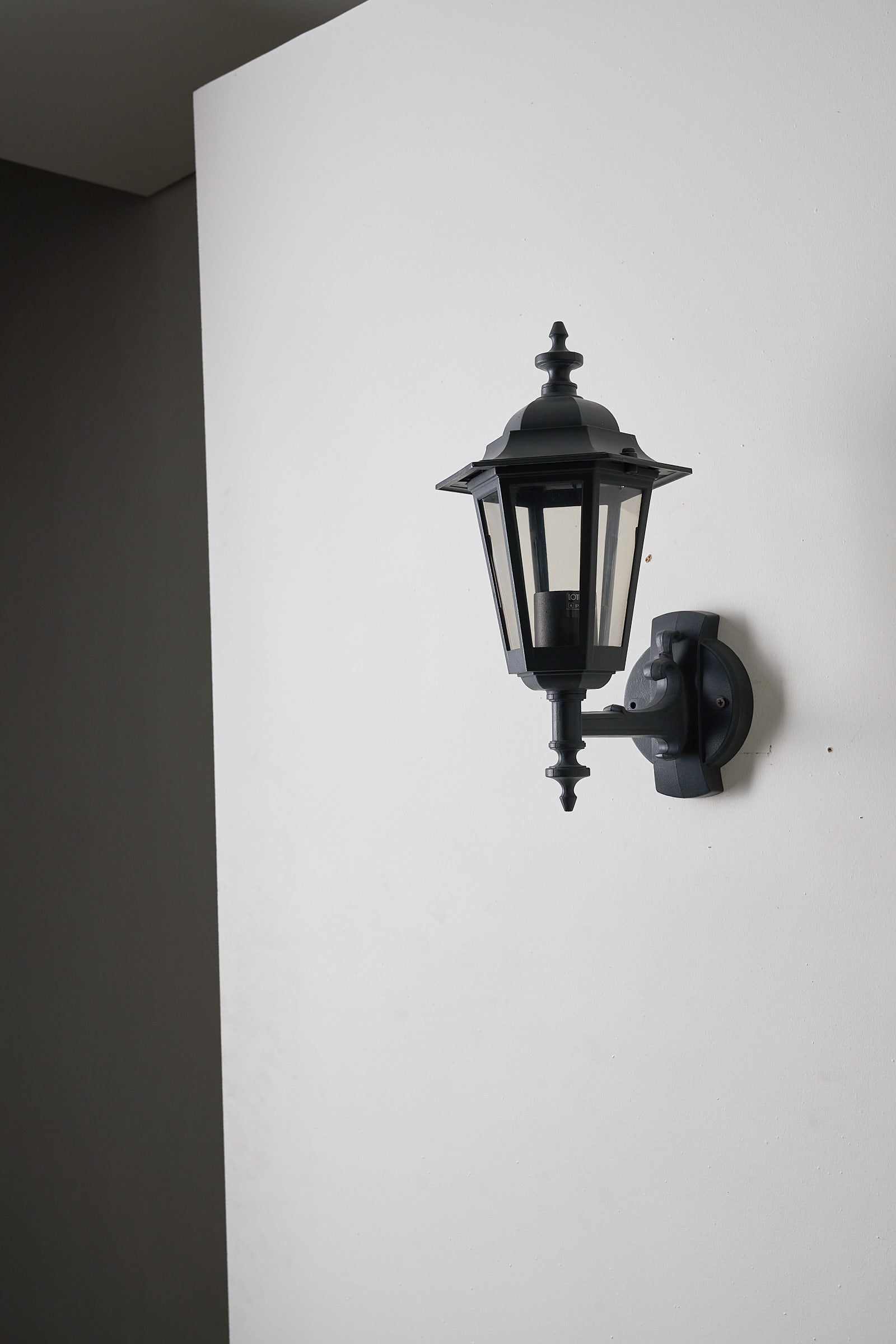 Pair of Traditional Outdoor Wall Lamps by Lothus (set) mounted on a wall, showcasing classic European lantern design.