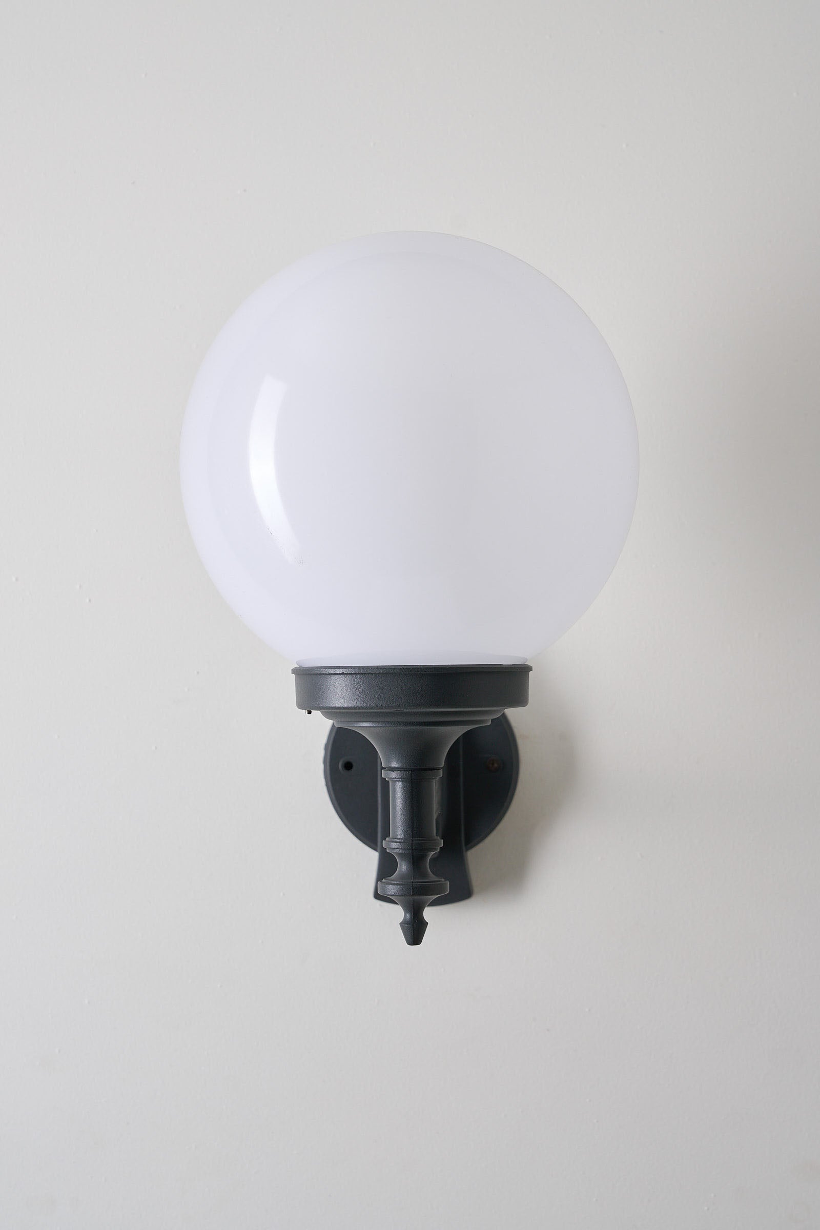 Traditional Outdoor Spherical Wall Lamp by Lothus mounted on a wall, providing elegant outdoor lighting.